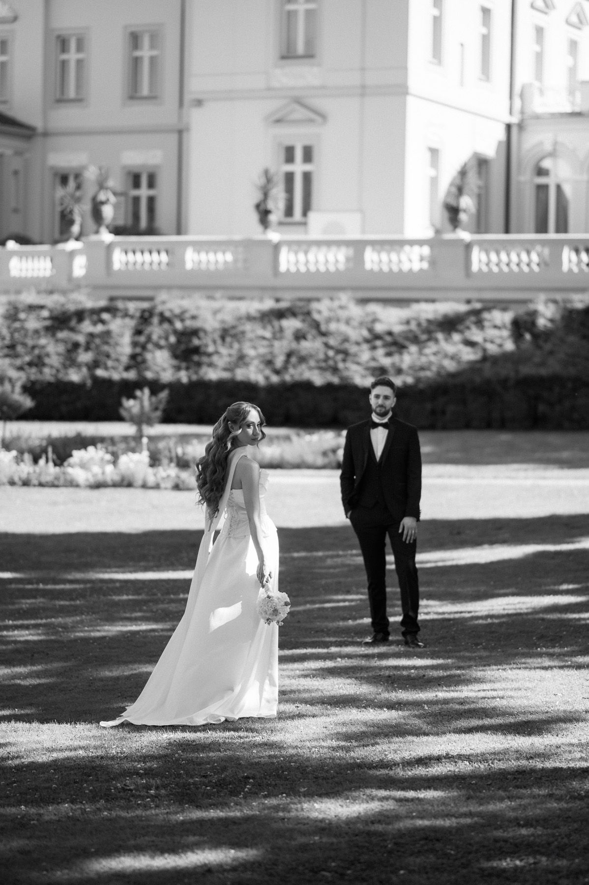 Bride and groom posing beside the historic Palanga estate