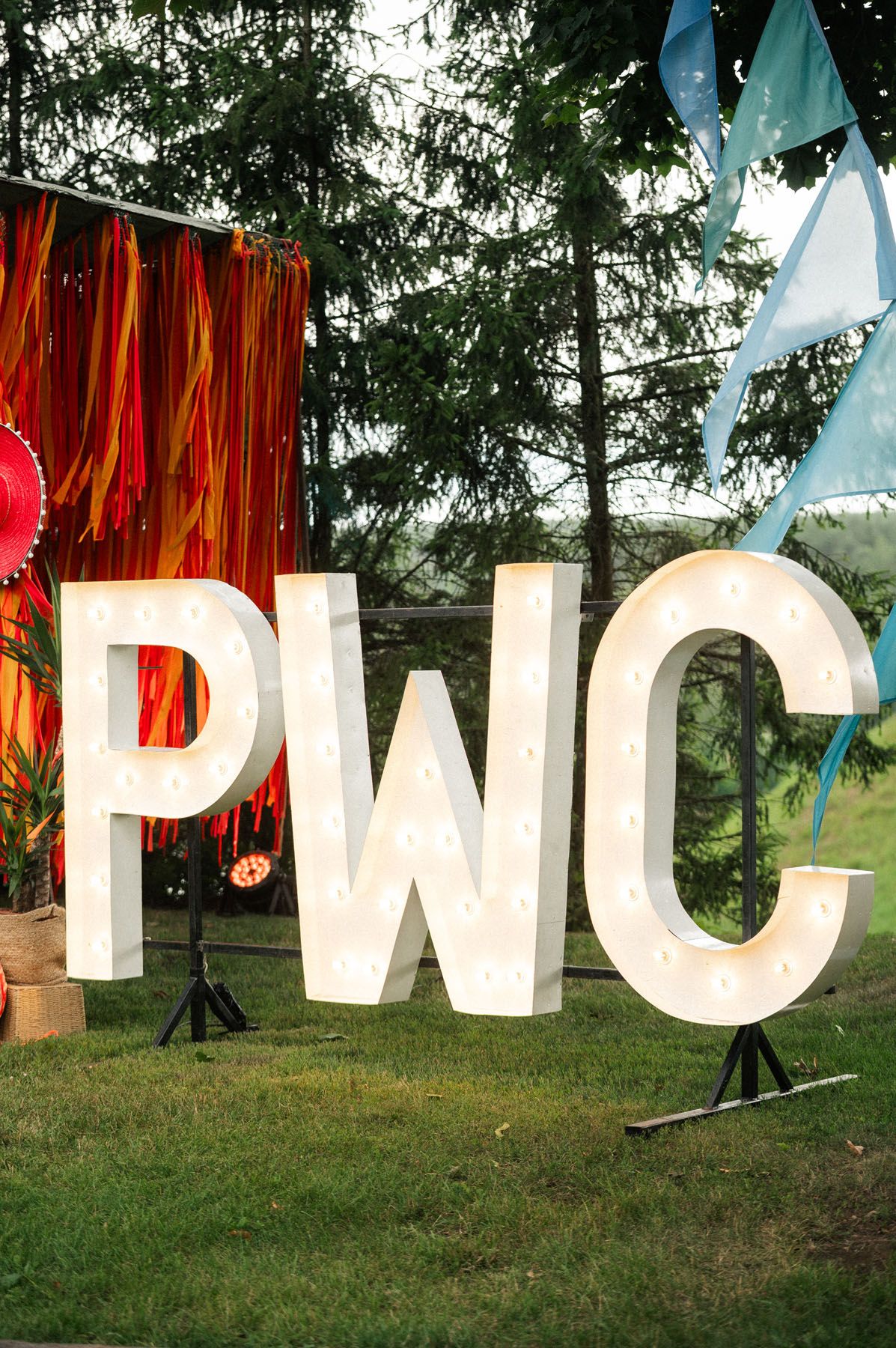 PWC event sign and Mexican-themed outdoor decorations
