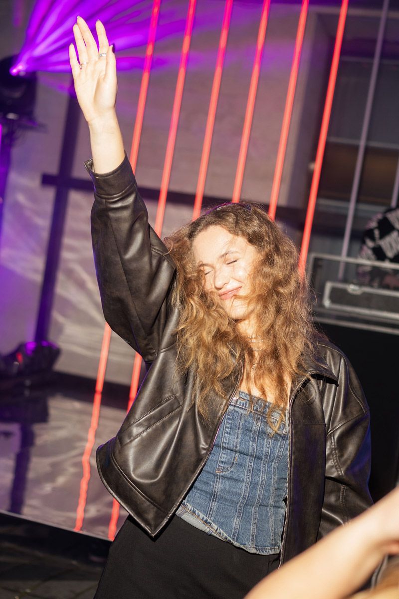 Woman enjoying the music at the Evoverse 2077 corporate event