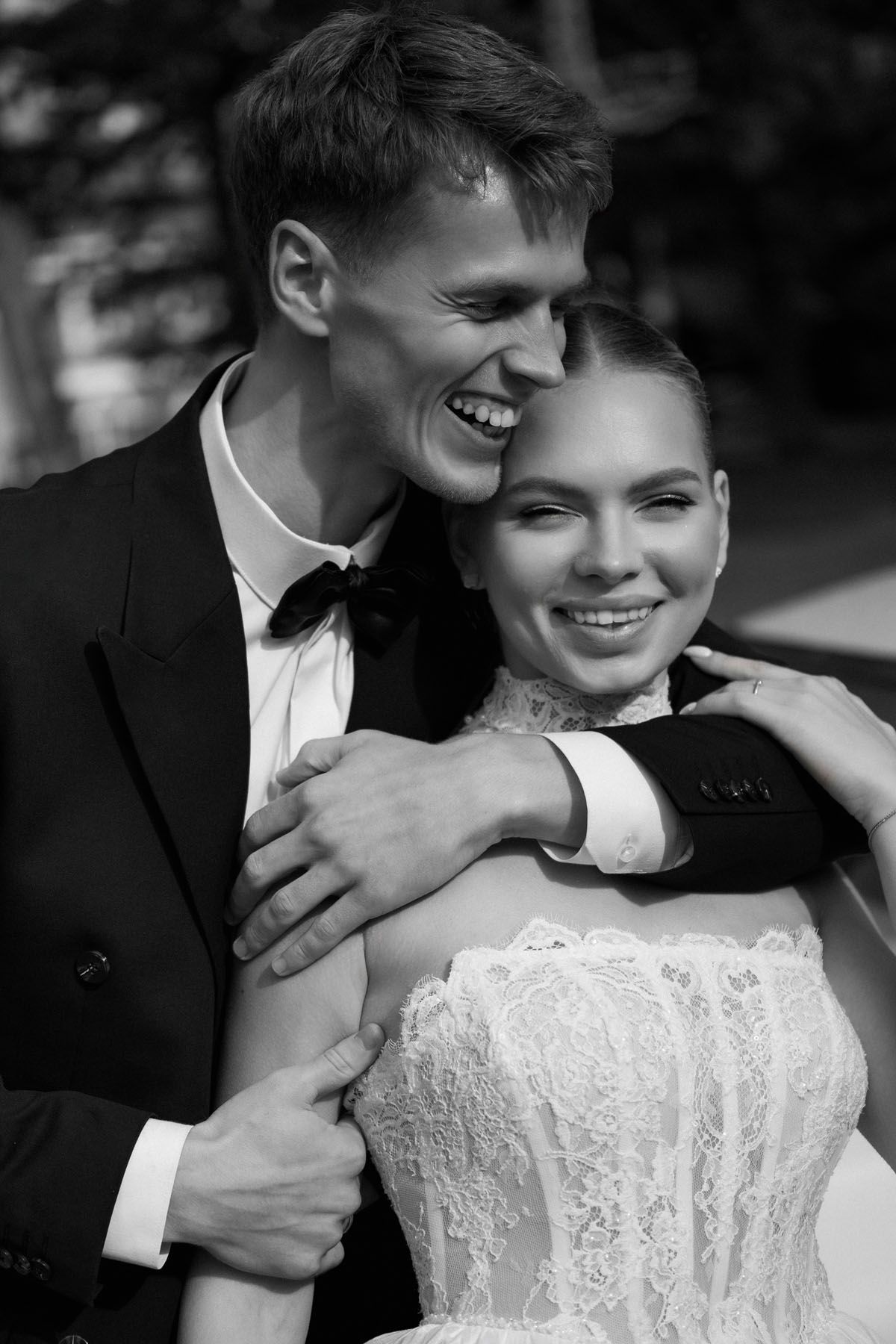 Bride and groom sharing a candid moment during their wedding in Kaunas