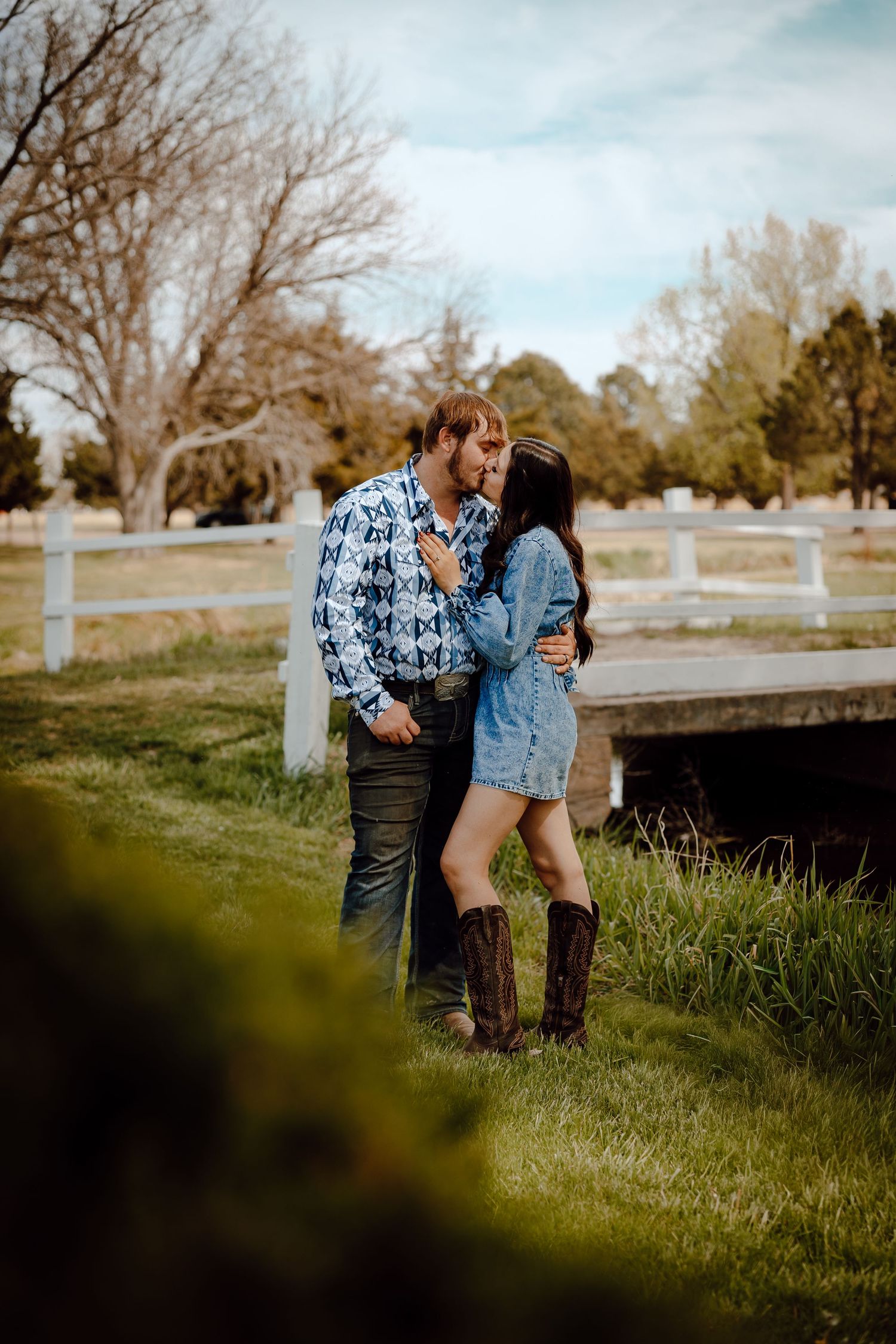 Western Nebraska Couples Session couple sharing a kiss outdoors in front of a white bridge