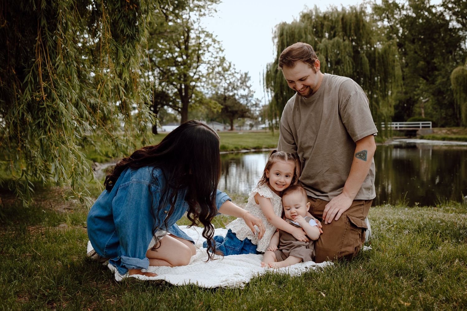 North Platte Nebraska Family Session parents lovingly interacting with their two young children.