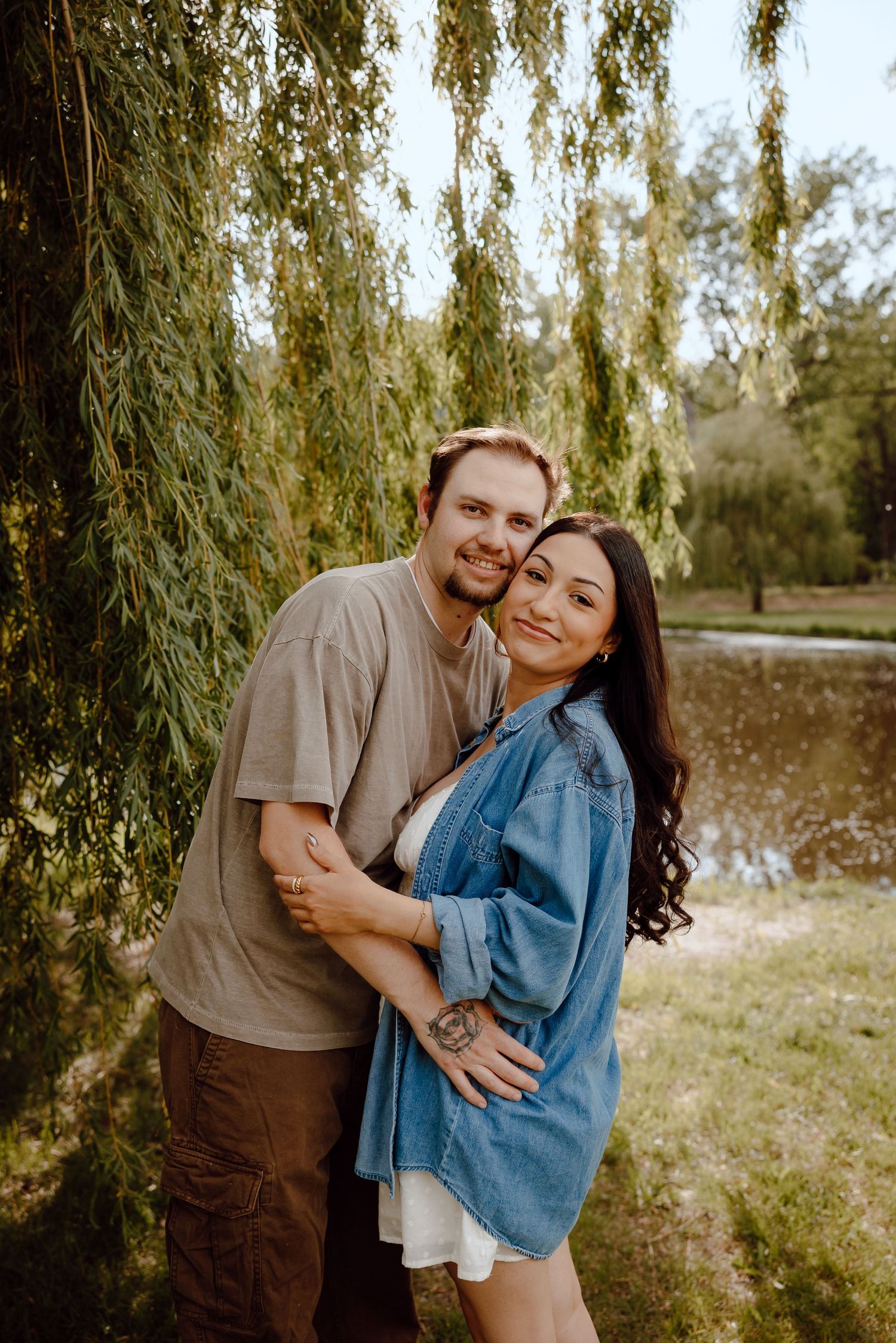 North Platte Nebraska Couples Session Couple embracing under weeping willow tree by a pond