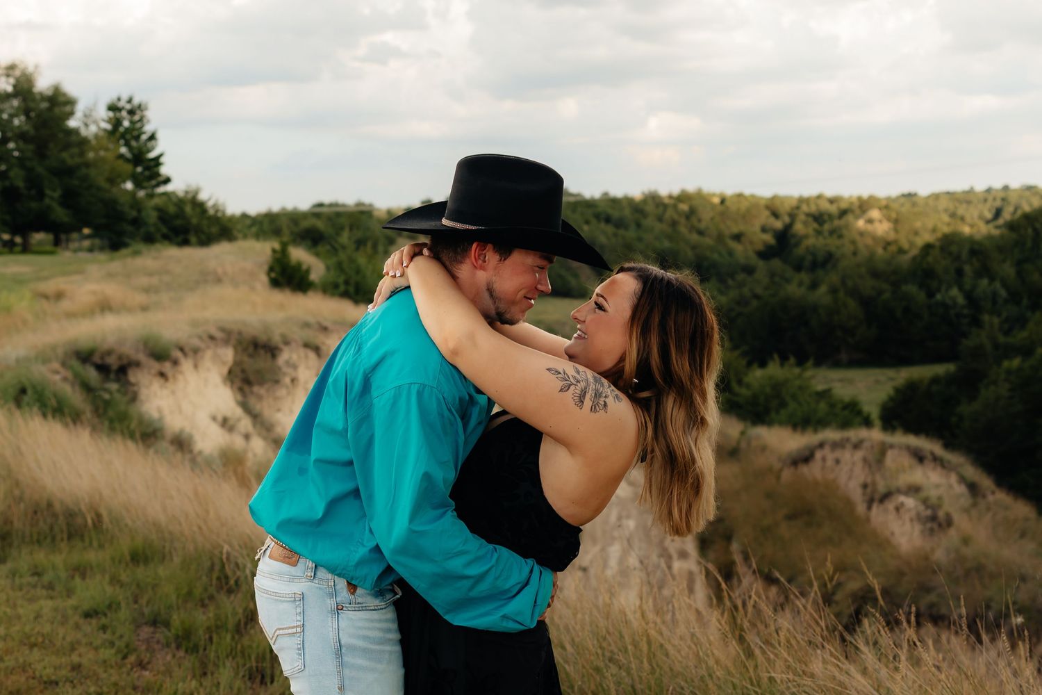 North Platte Nebraska Couples Session Couple embracing in a scenic meadow