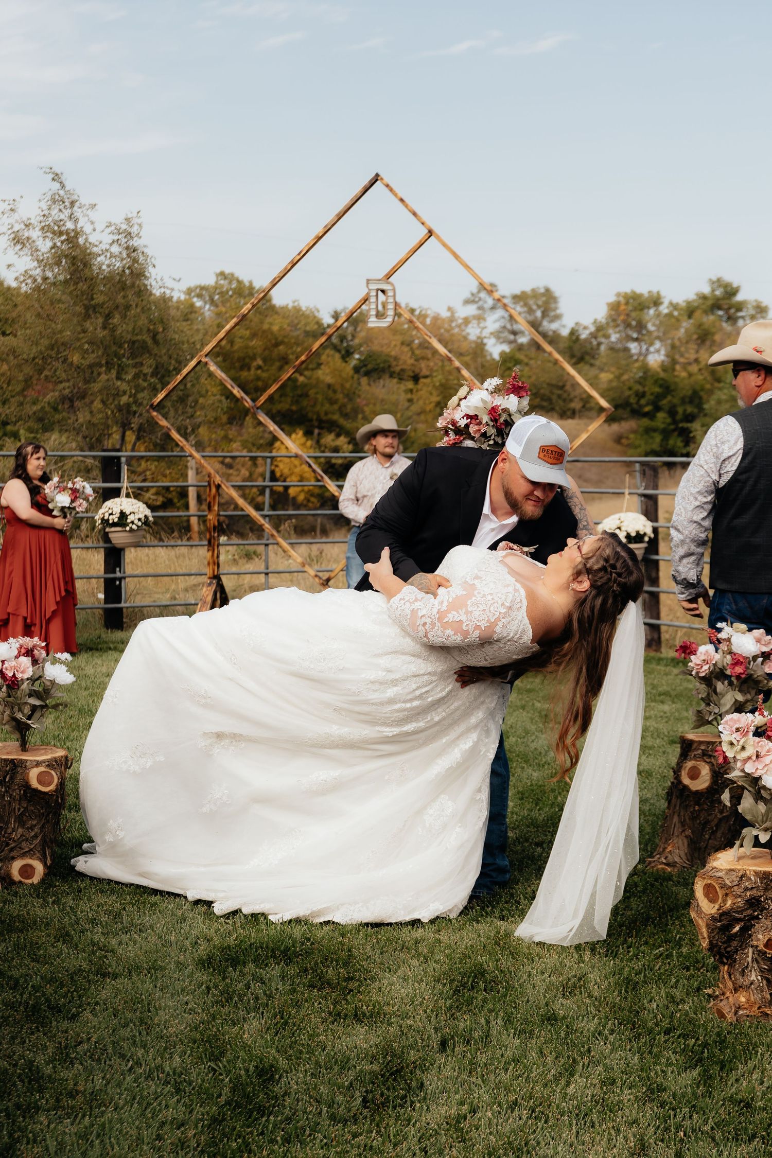 Western Nebraska Wedding Bride and groom share a romantic dip kiss at outdoor rustic wedding ceremony