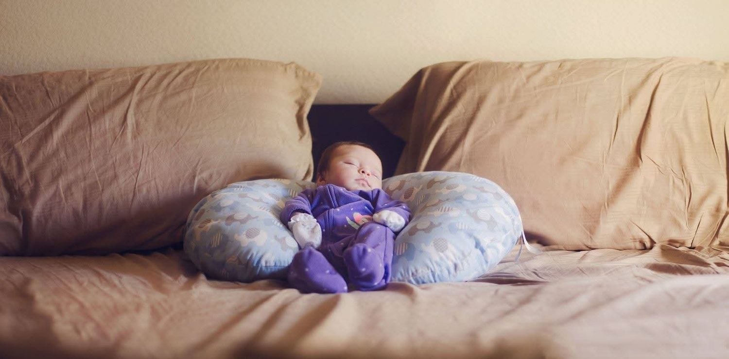 Newborn photography on bed with pillow in Johnstown, Pennsylvania