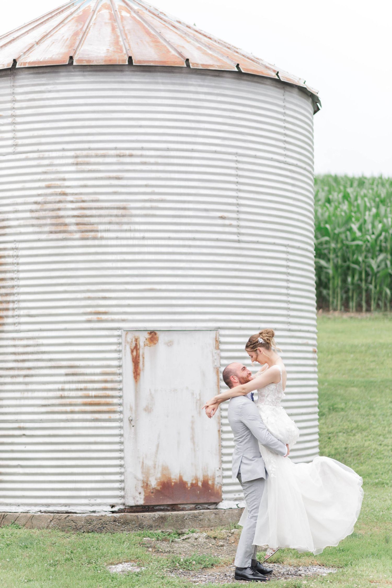 Bride and groom in front of silo at Joiner Farms in Northern Cambria, Pennsylvania