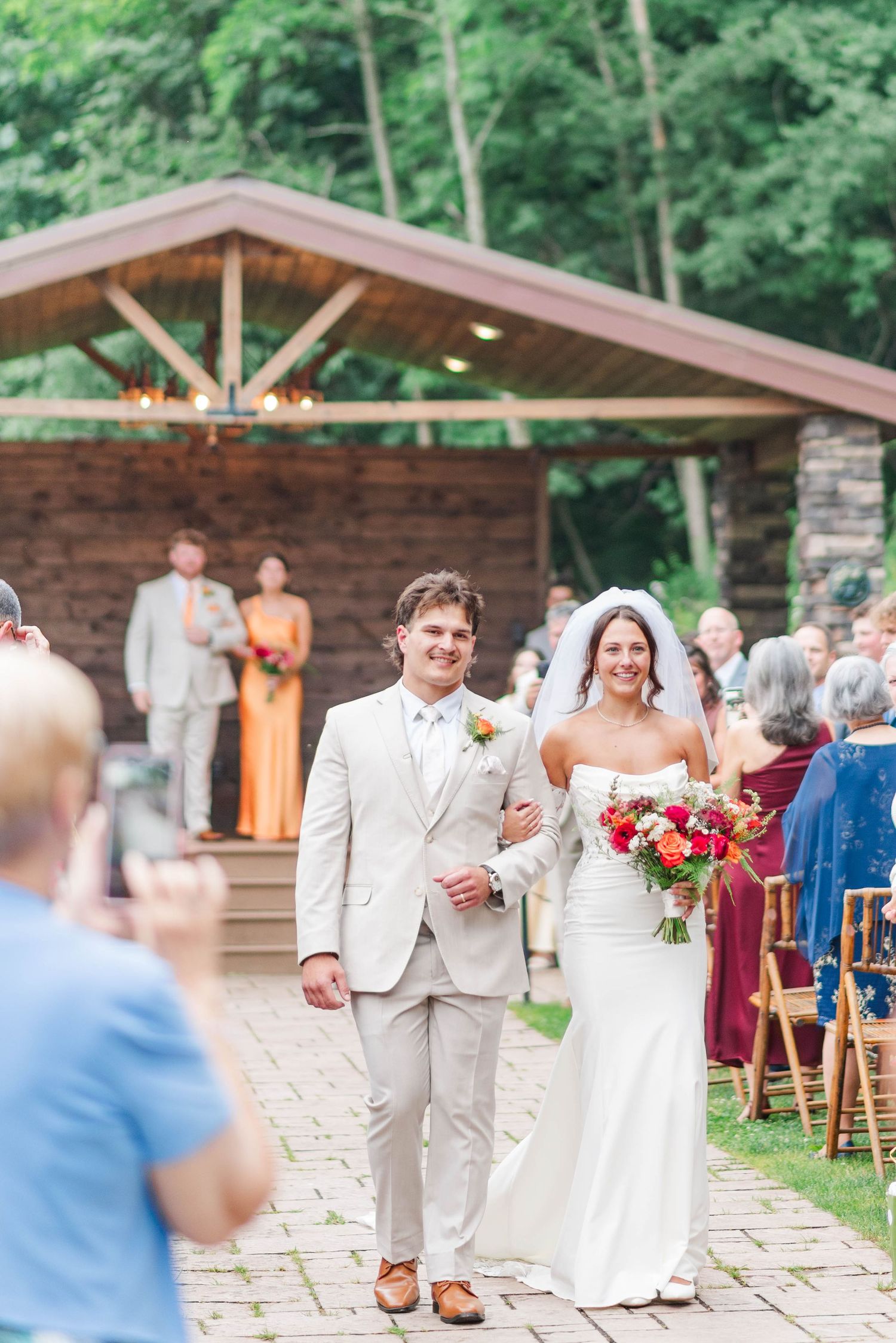 Just married walking down the aisle at Whispering Hollow Estates in Pleasantville, Pennsylvania