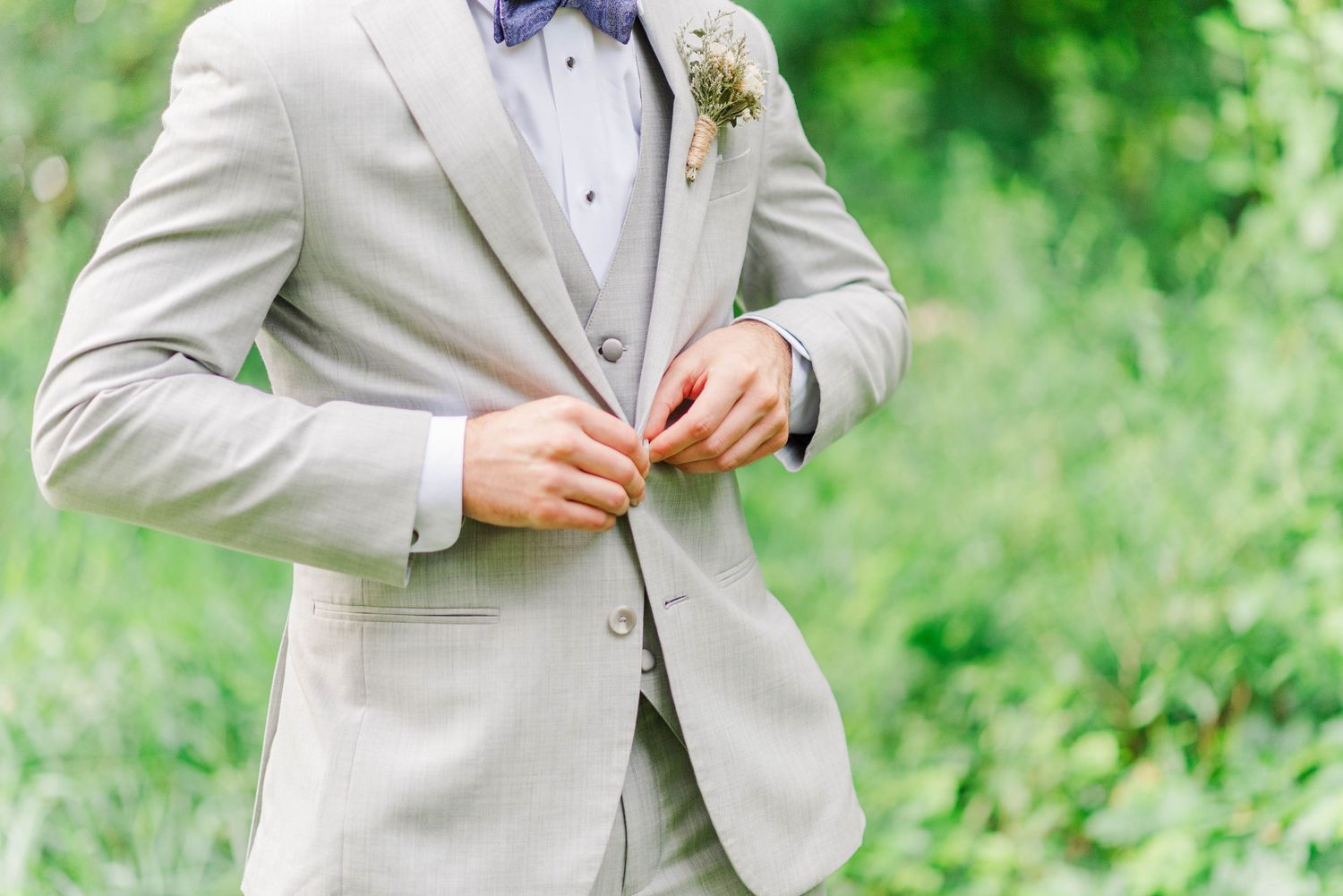 Groom buttoning jacket at Joiner Farms in Northern Cambria, Pennsylvania