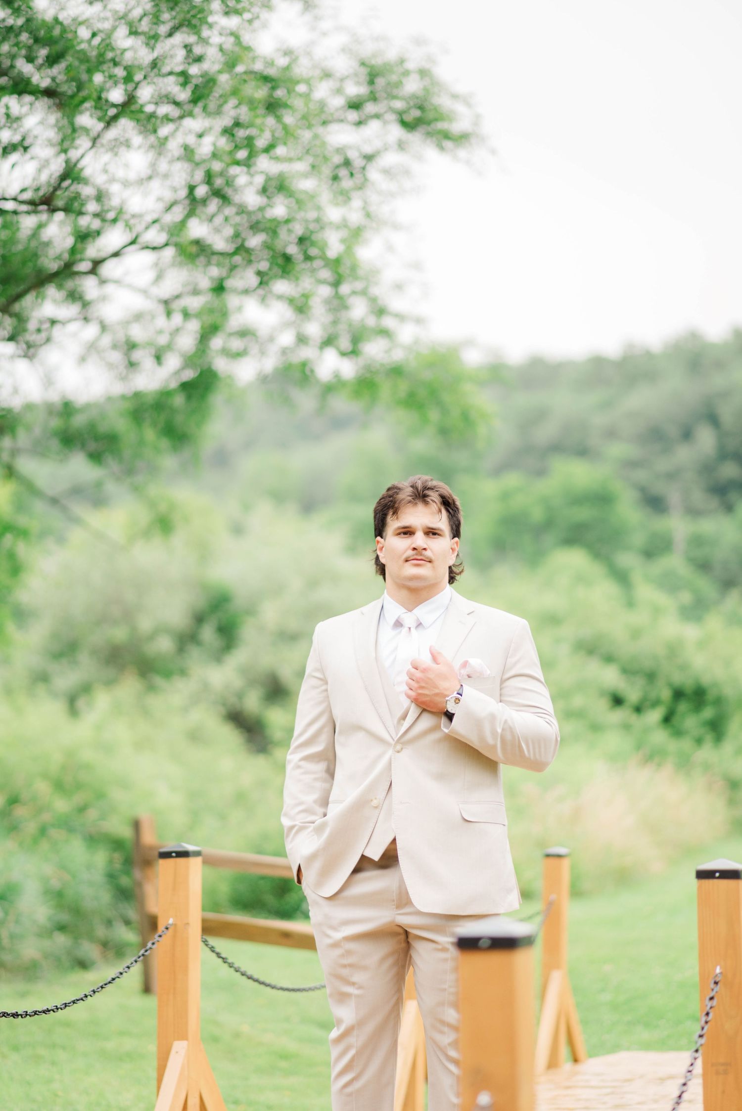 Groom standing at Whispering Hollow Estates in Pleasantville, Pennsylvania