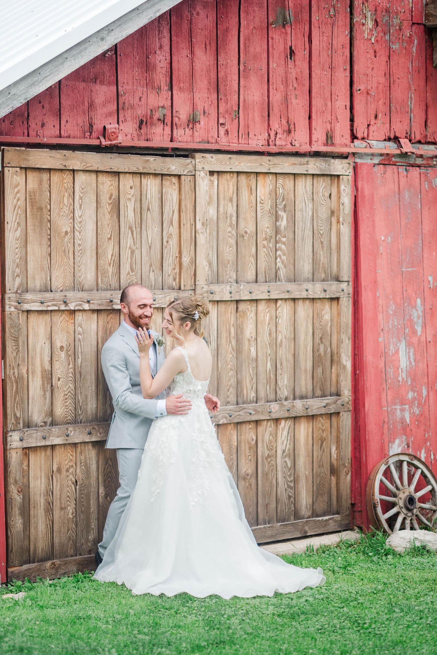 Bride and groom beside the barn at Joiner Farms in Northern Cambria, Pennsylvania