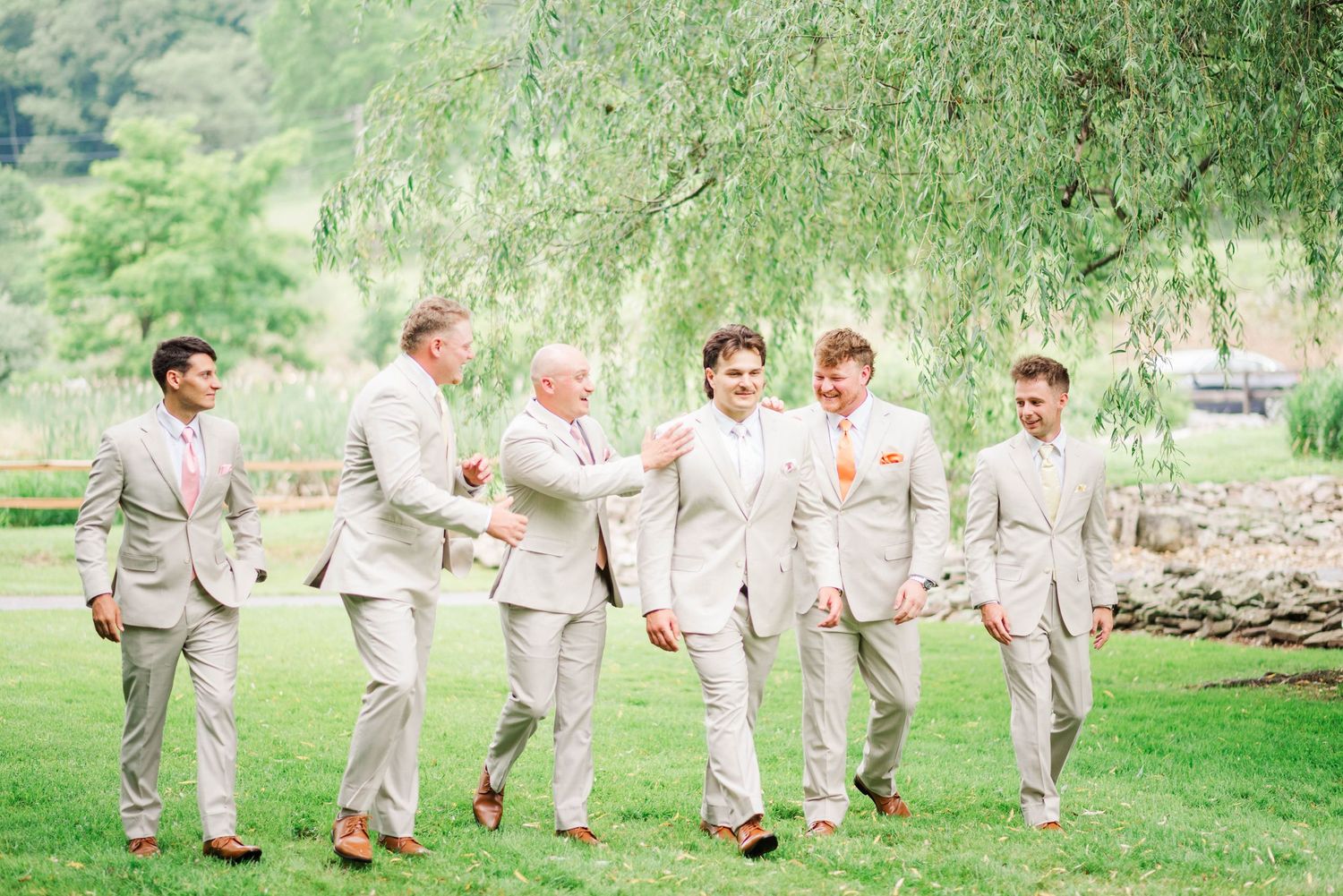Groomsmen walking together at Whispering Hollow Estates in Pleasantville, Pennsylvania