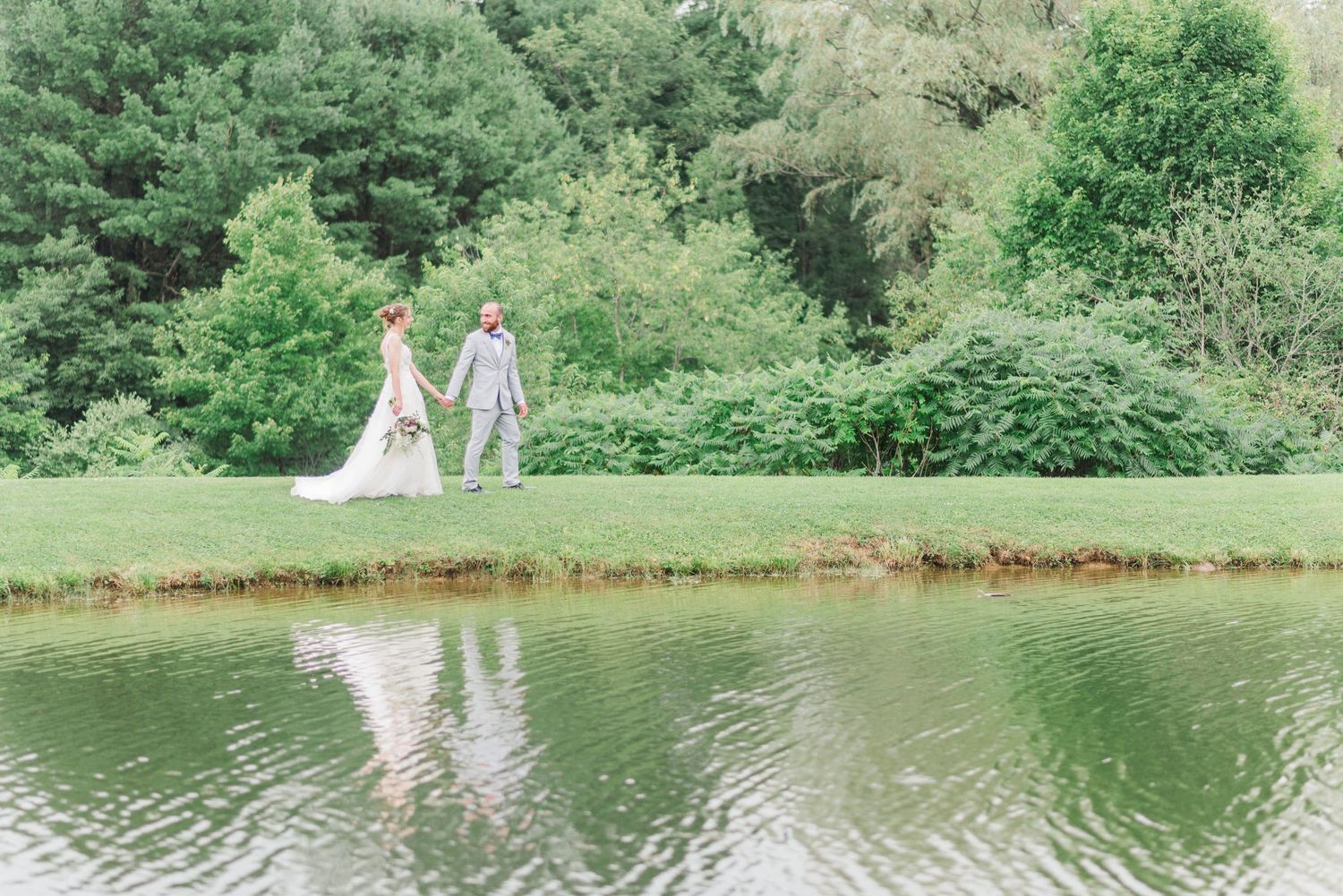 Couple walking together next to lake at Joiner Farms in Northern Cambria, Pennsylvania