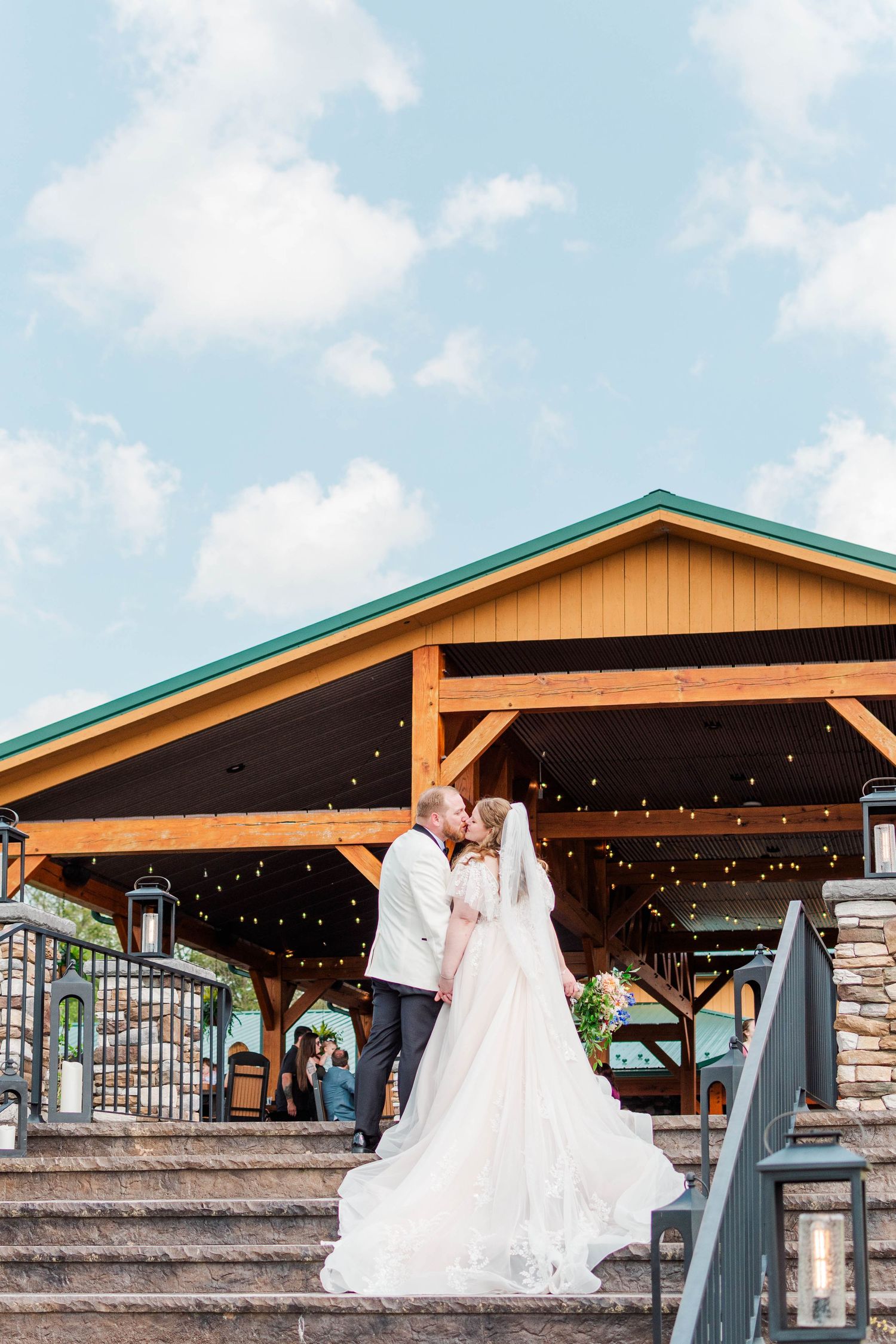 Bride and Groom kissing on stairs at the Roost in Mahaffey, Pennsylvania
