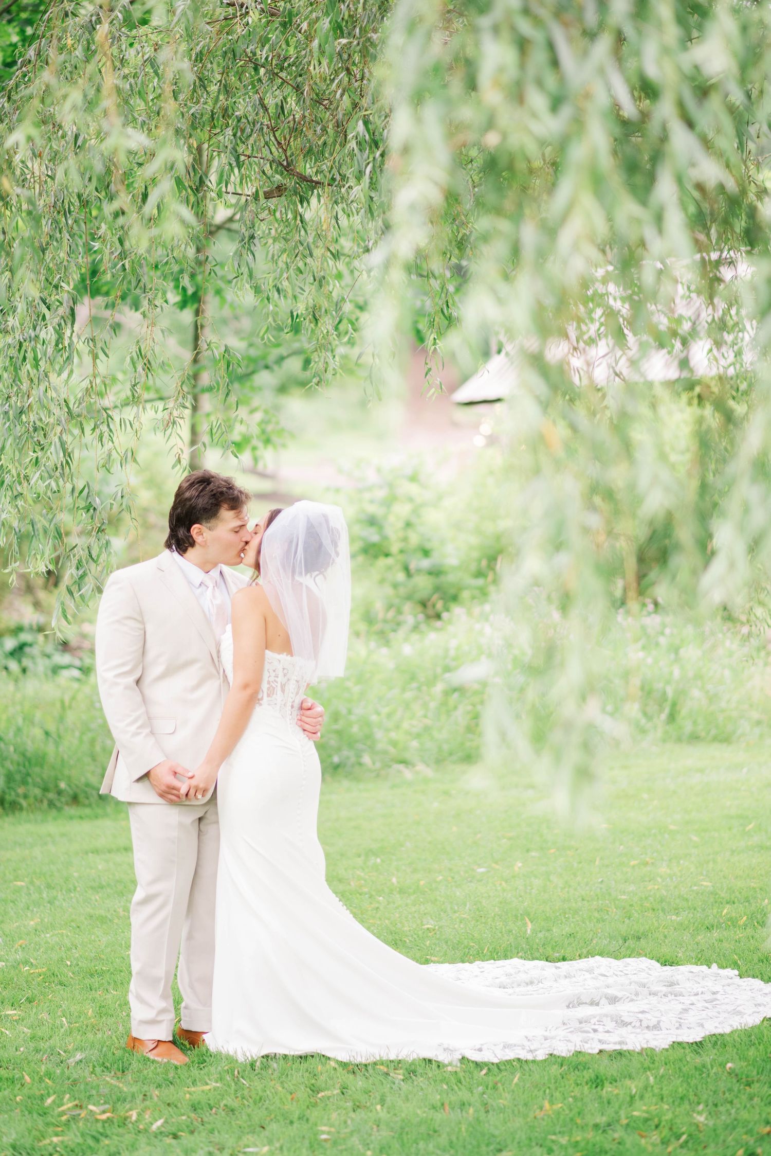 Bride and groom under willow tree at Whispering Hollow Estates in Pleasantville, Pennsylvania