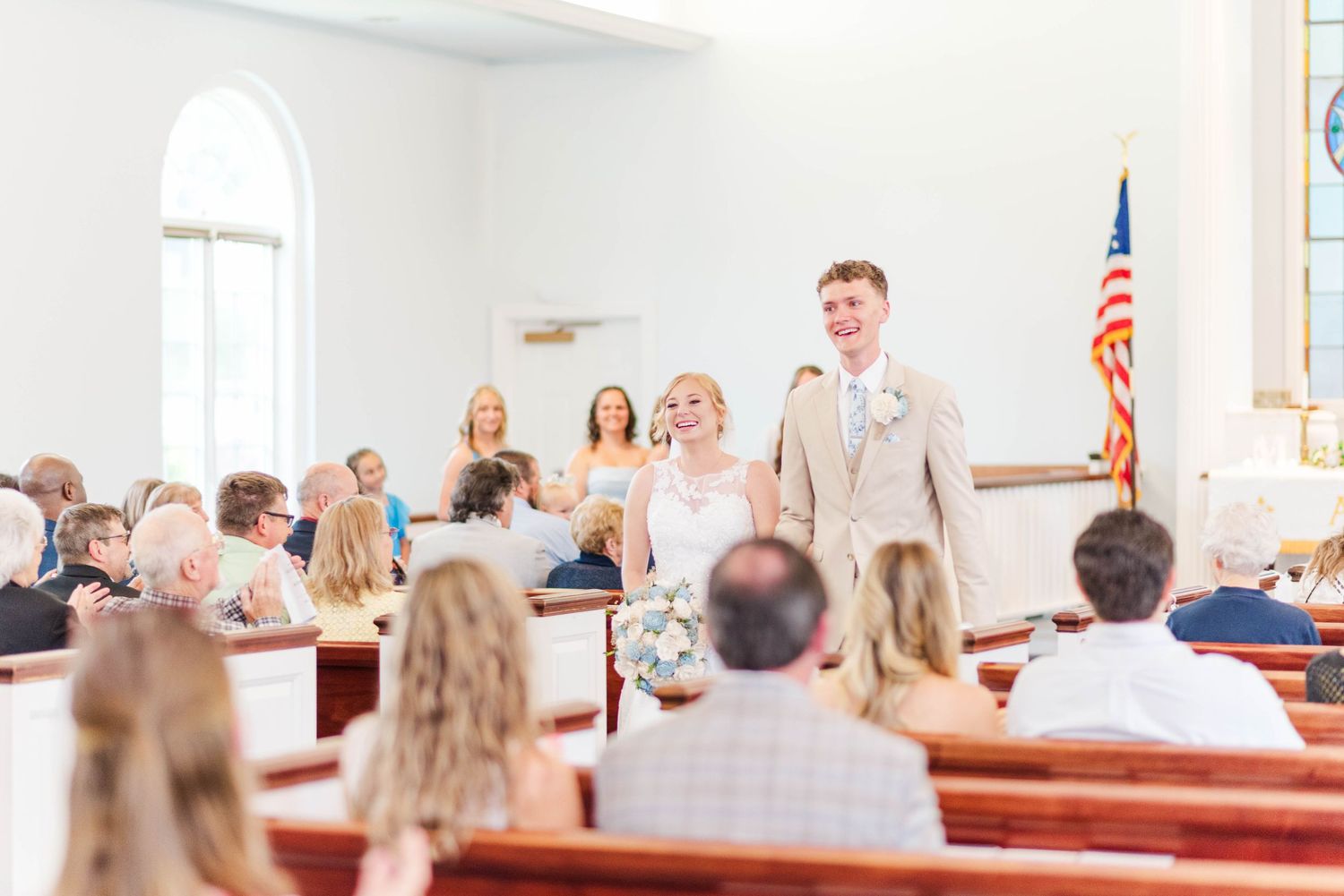 Bride and groom walk with the aisle just married in Johnstown, Pennsylvania