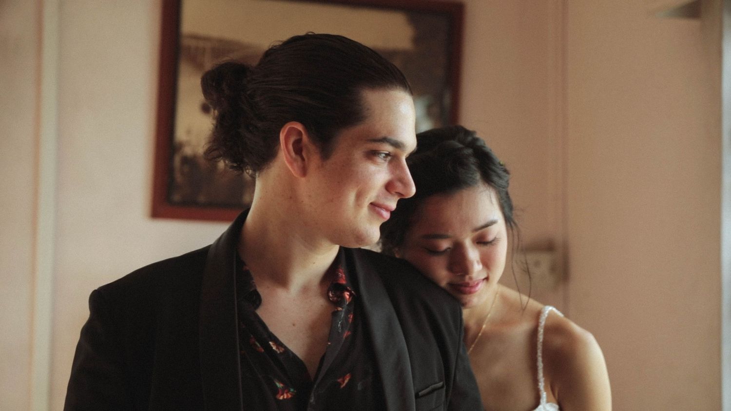 Couple looking outside captured by Singapore wedding videographer