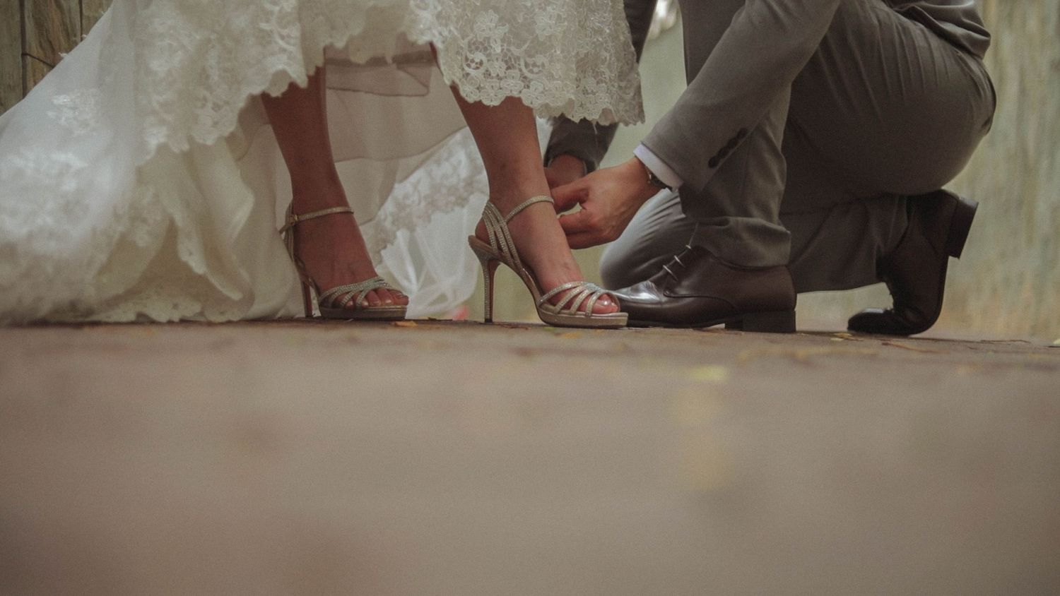 Groom tying bride's high-heels captured by Singapore wedding videographer