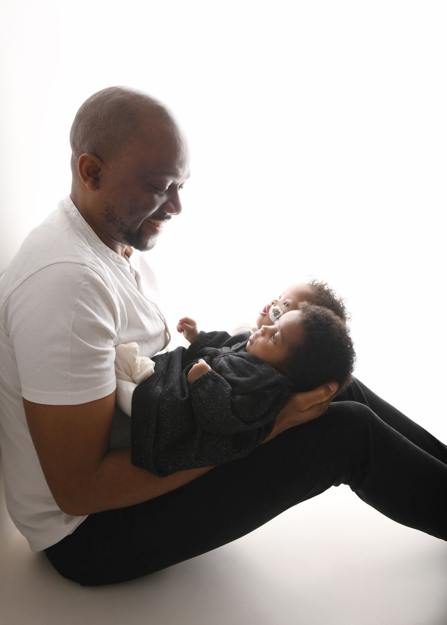 Father holding his newborn baby during a studio portrait session