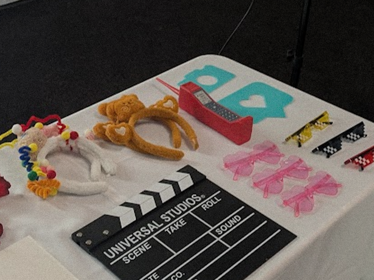 Stylishly arranged table featuring premium event props, cool sunglasses, and signs for photobooth fun.