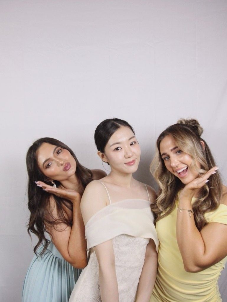 Small group of friends posing for a classic photo in our Sydney standard-angle photobooth.