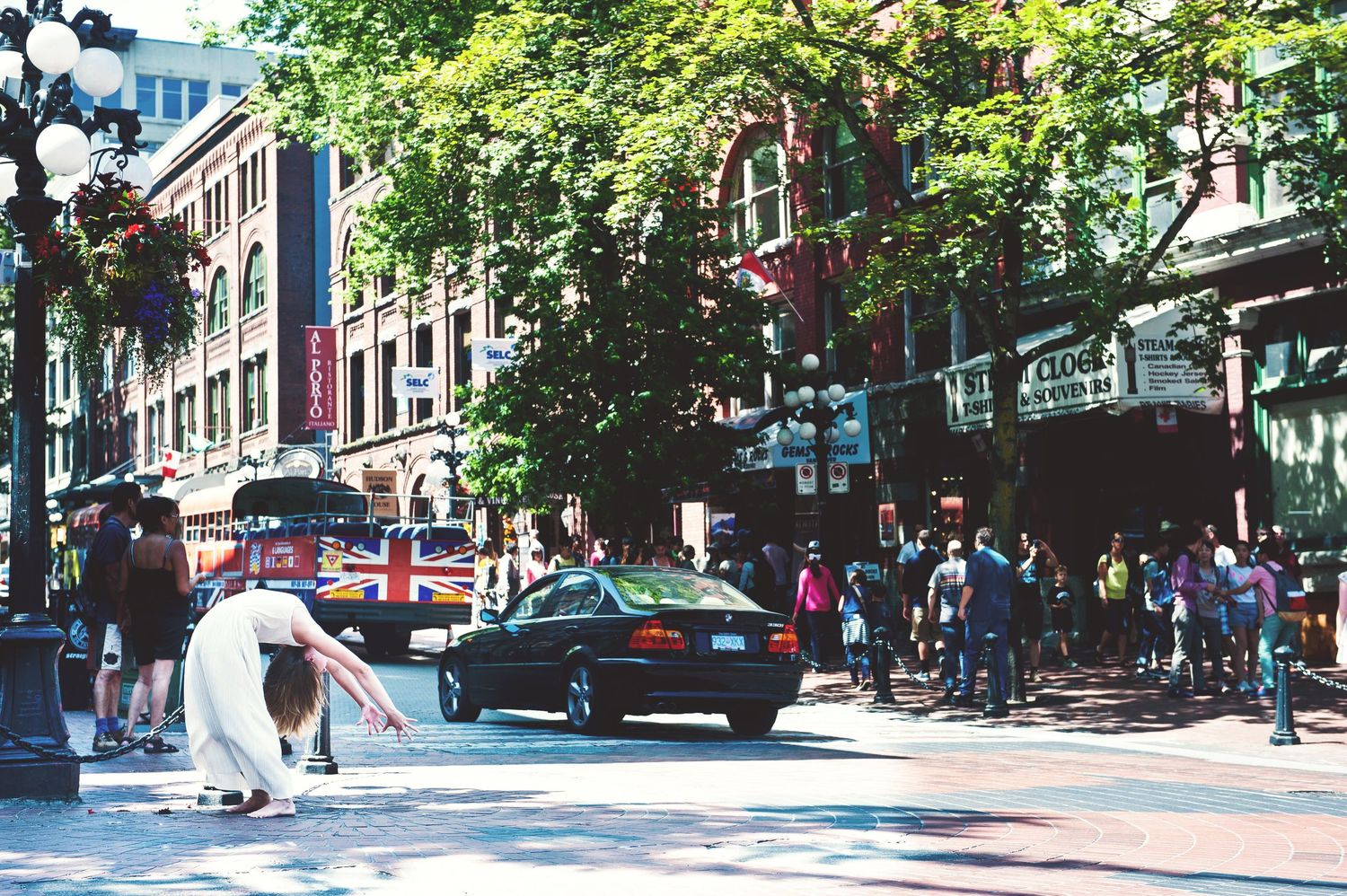 Portrait of a woman in an extreme yoga pose in the streets of Gastown, Vancouver, British Columbia.