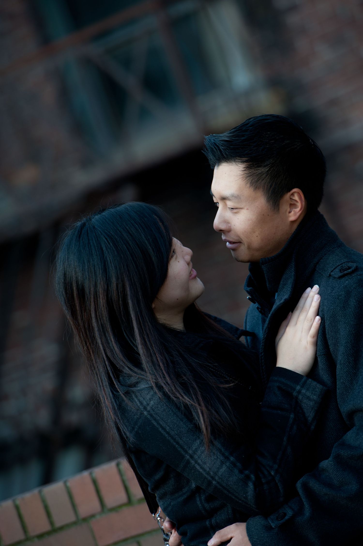 Couple sharing a quiet moment during an engagement session in downtown Vancouver, British Columbia.