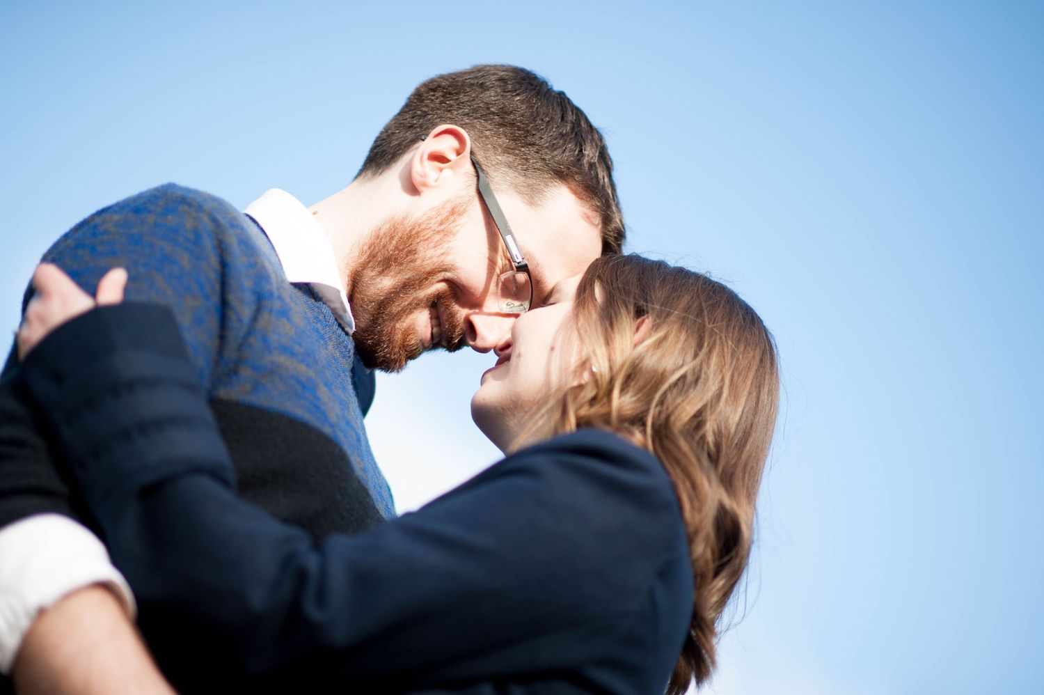 Couple sharing a kiss during an engagement session at a botanical garden in Vancouver, British Columbia.