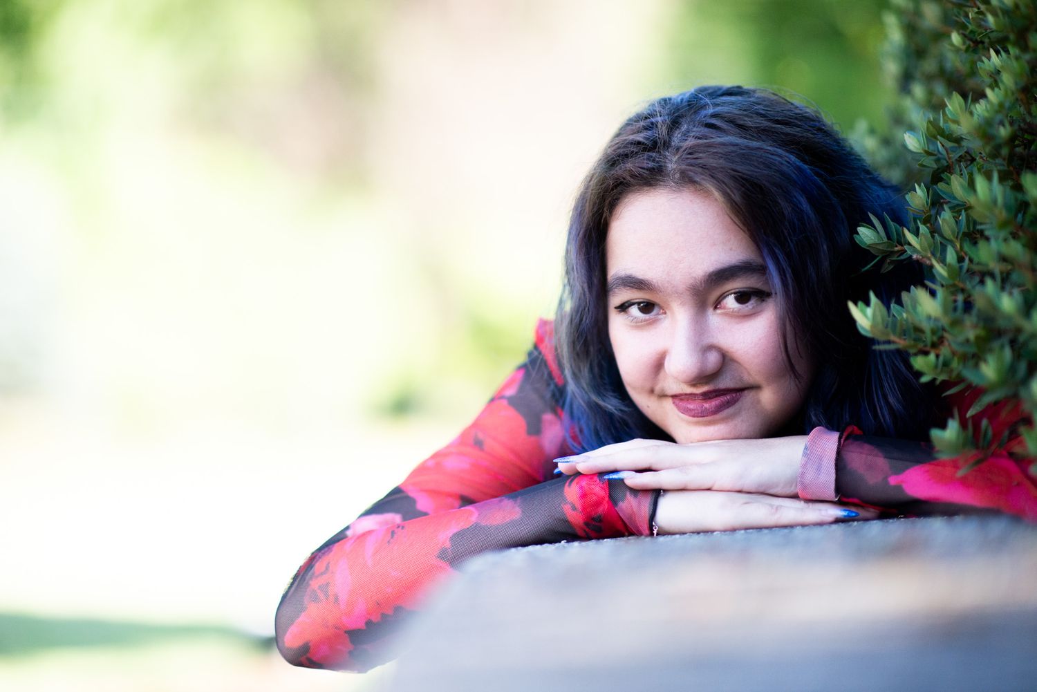 Outdoor graduation portrait of a smiling teenage girl in Chilliwack, British Columbia.