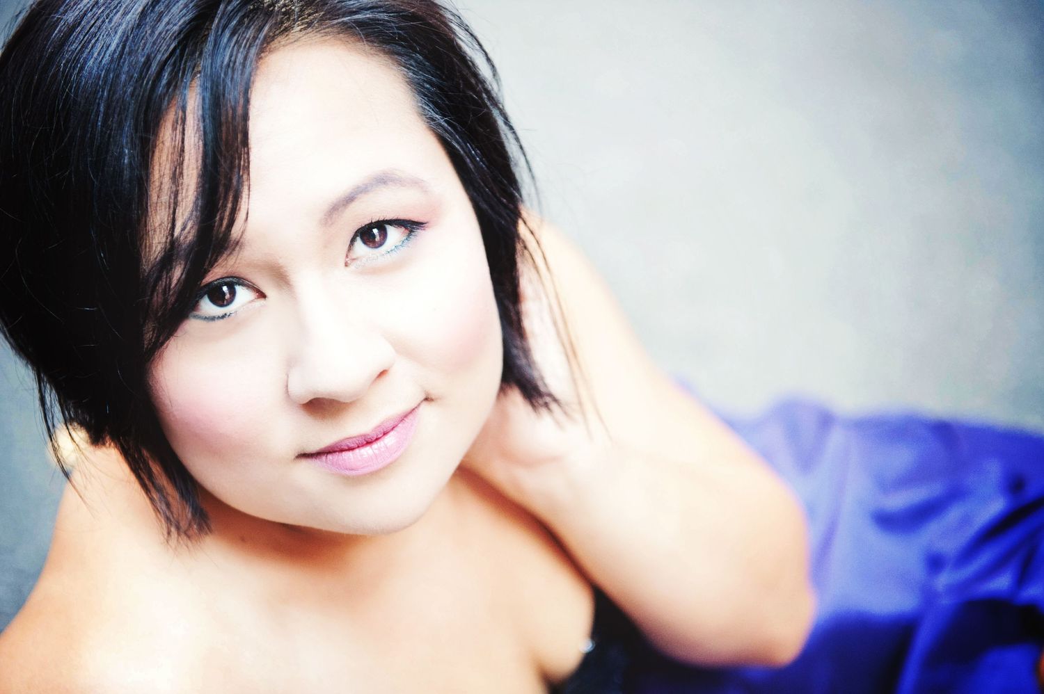 Graduation portrait of a young woman wearing a blue dress in Vancouver, British Columbia.