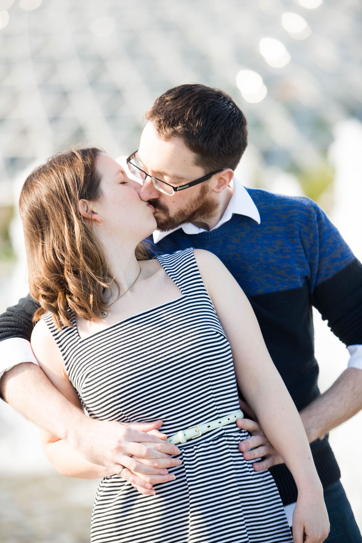 Couple sharing a kiss during an engagement session at a botanical garden in Vancouver, British Columbia.