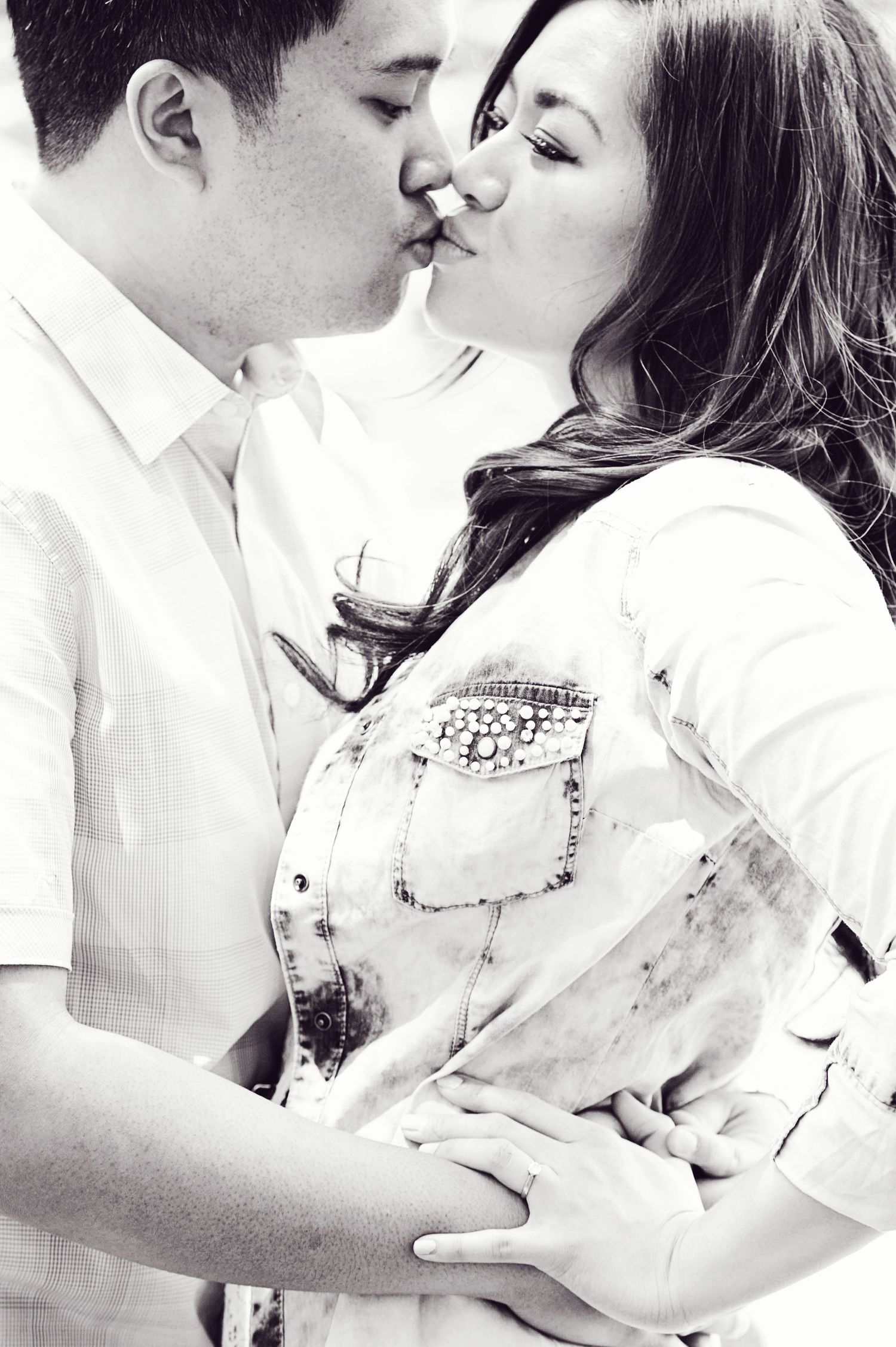 Black-and-white portrait of a couple sharing a kiss during an engagement session in Burnaby, British Columbia.