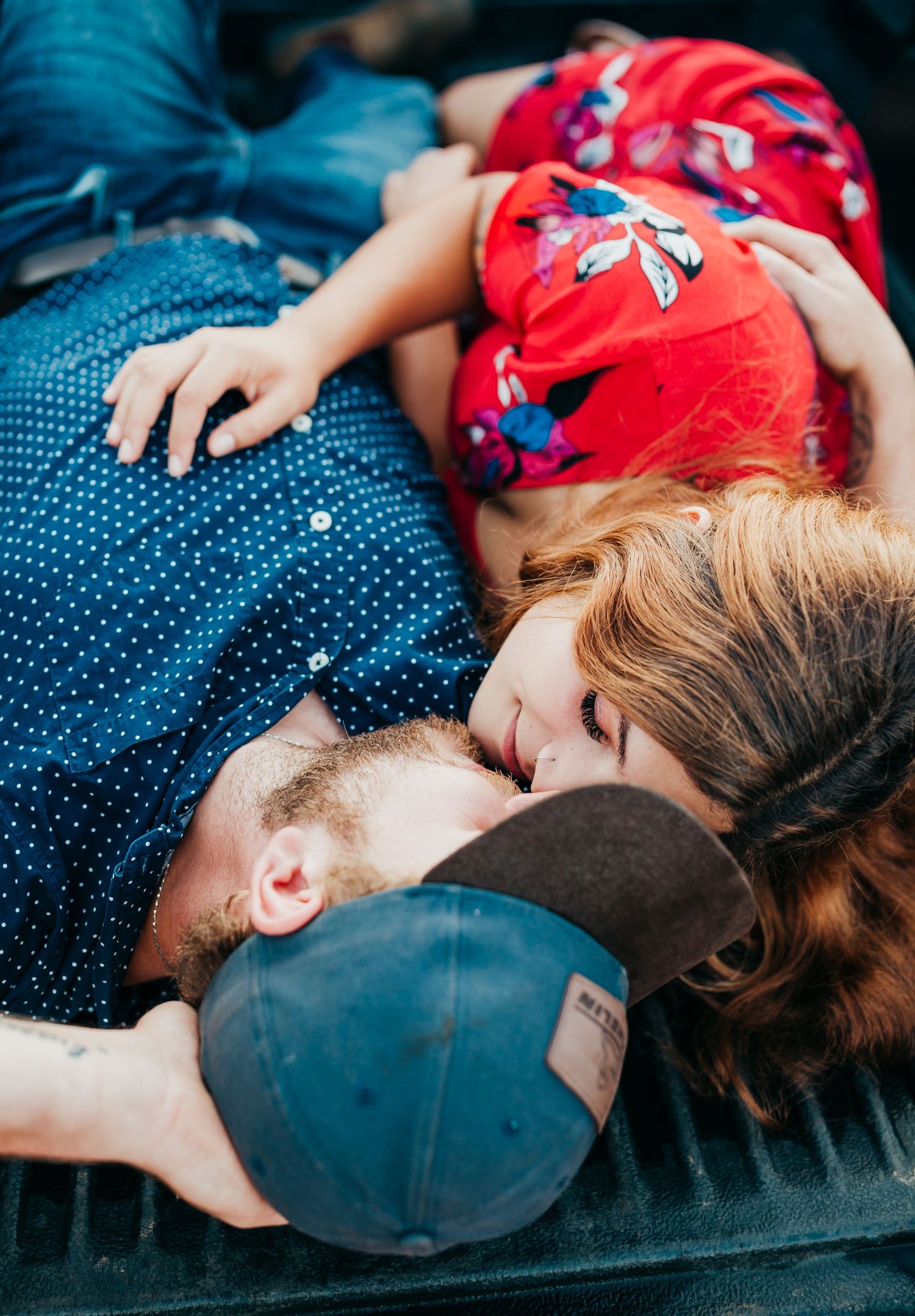 Tender aerial view of two people lying close together during an intimate moment.