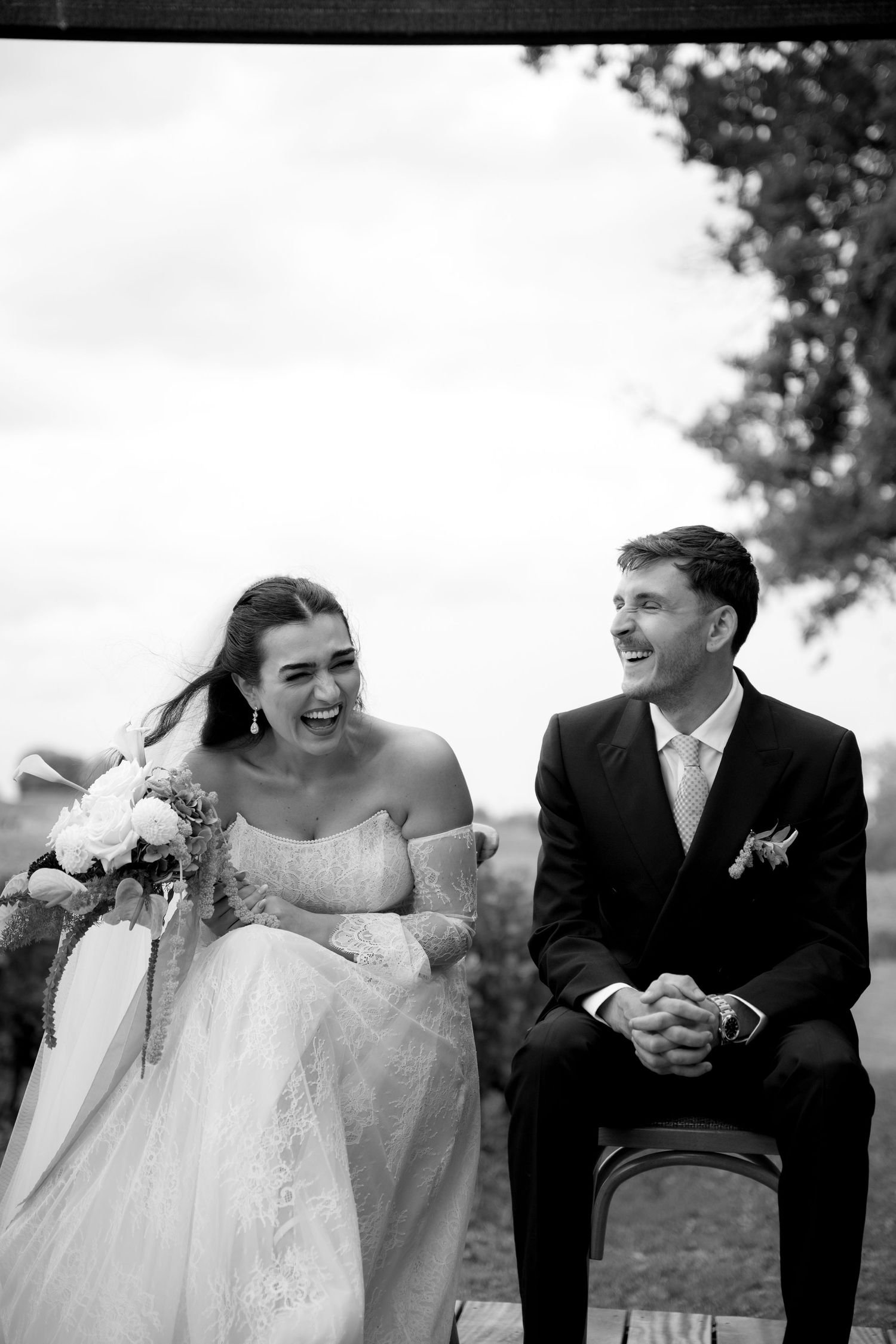Black and white sequence capturing candid laughter and joy during wedding portraits.