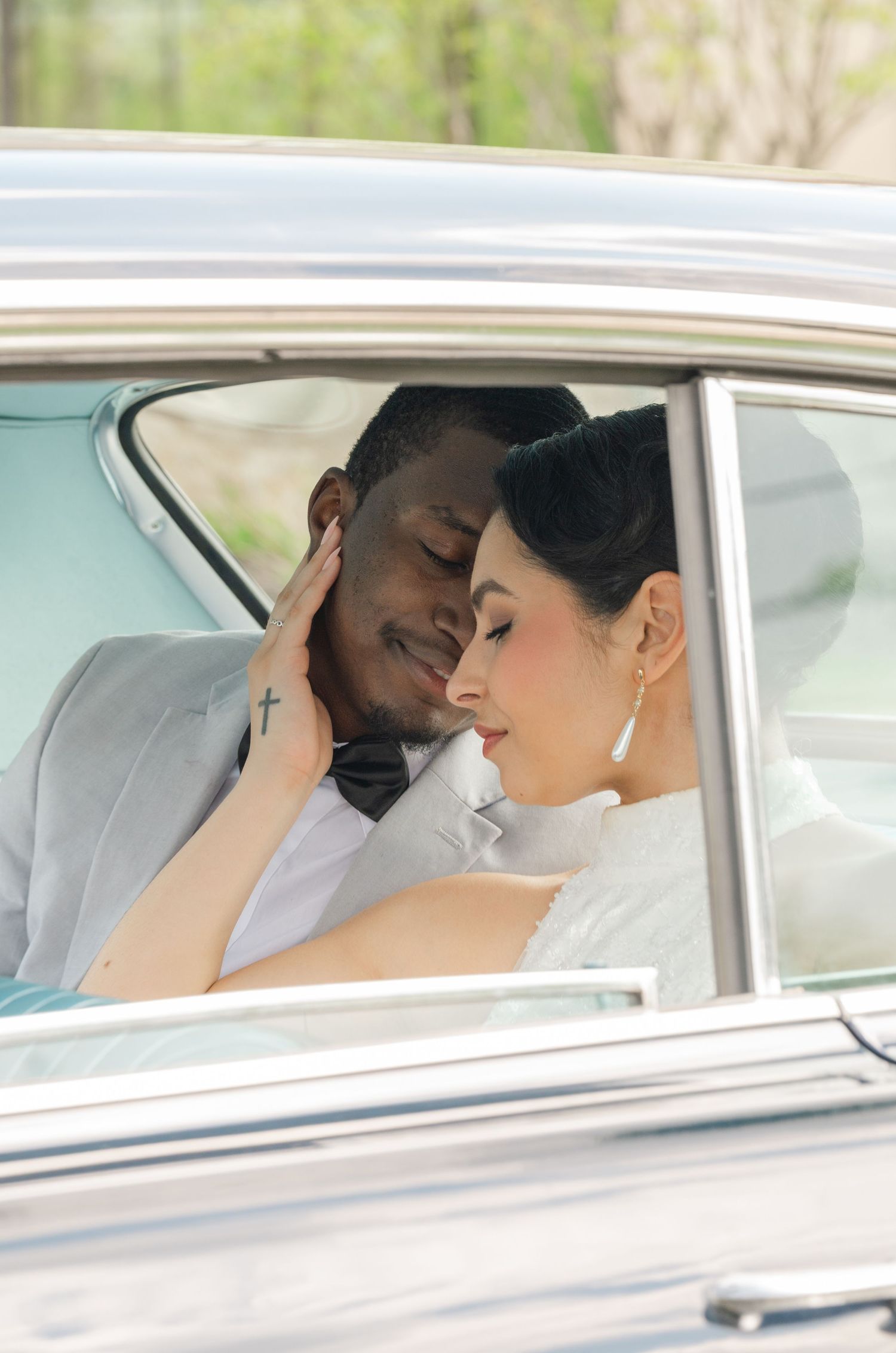 bride and groom embracing in a old fashion car
