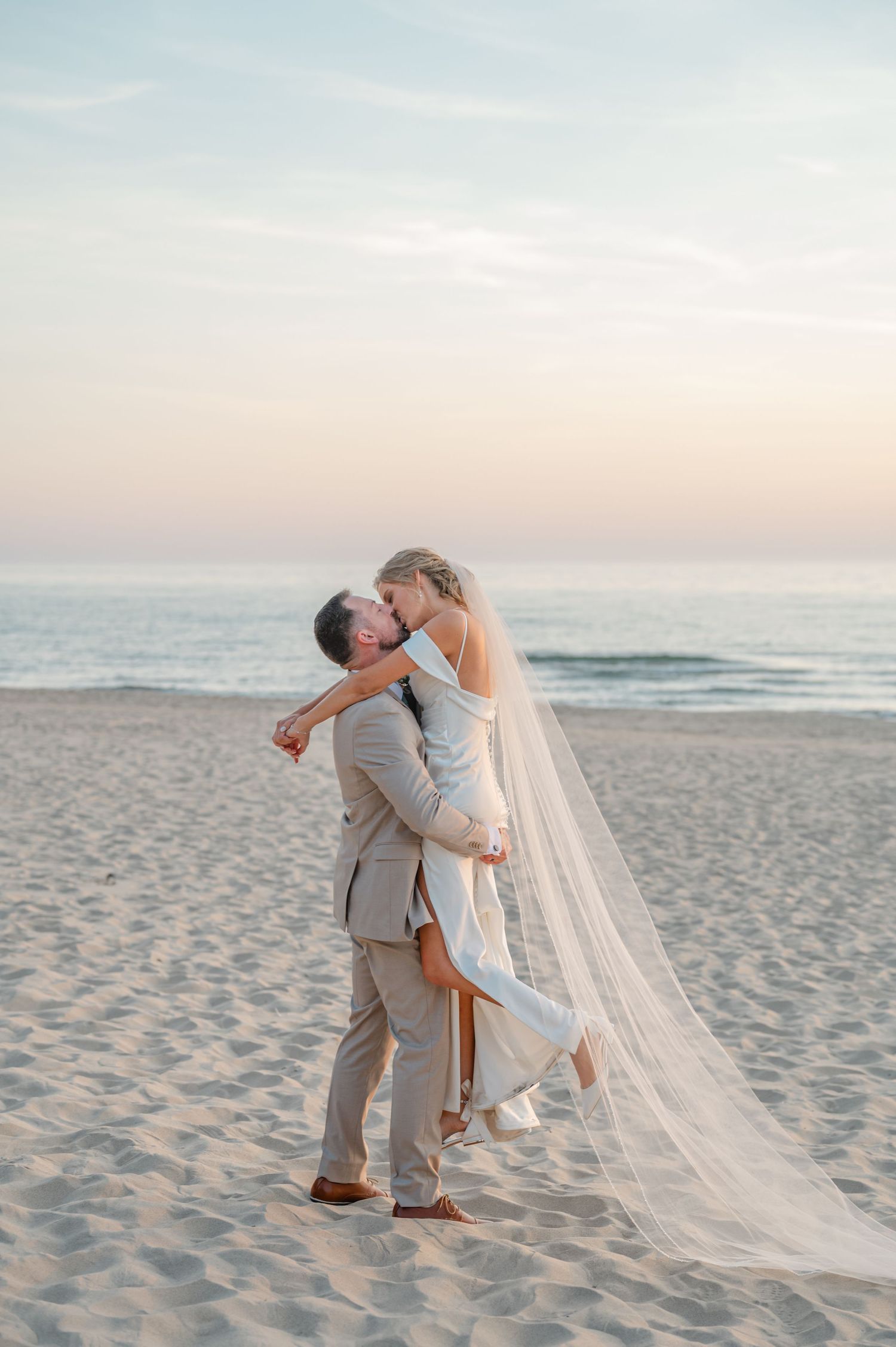 wedding couple, groom picking up bride and kissing her