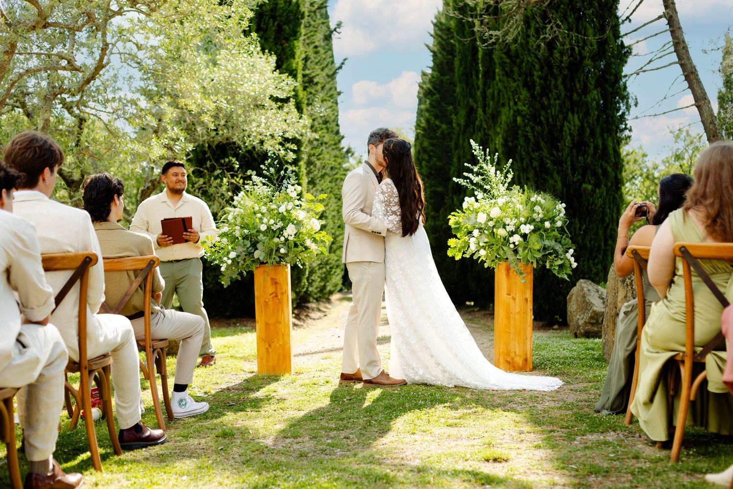 Wedding ceremony seating arrangement in a rustic outdoor garden setting.