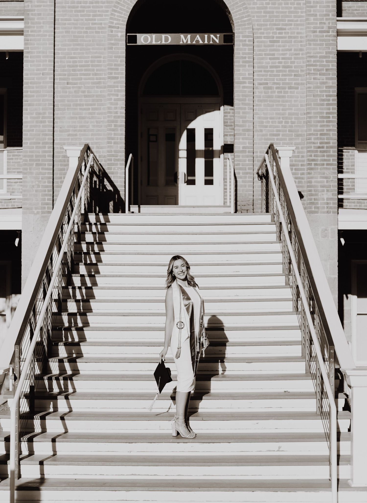 Vintage-style sequence showing graduate ascending white stone steps at Old Main building.
