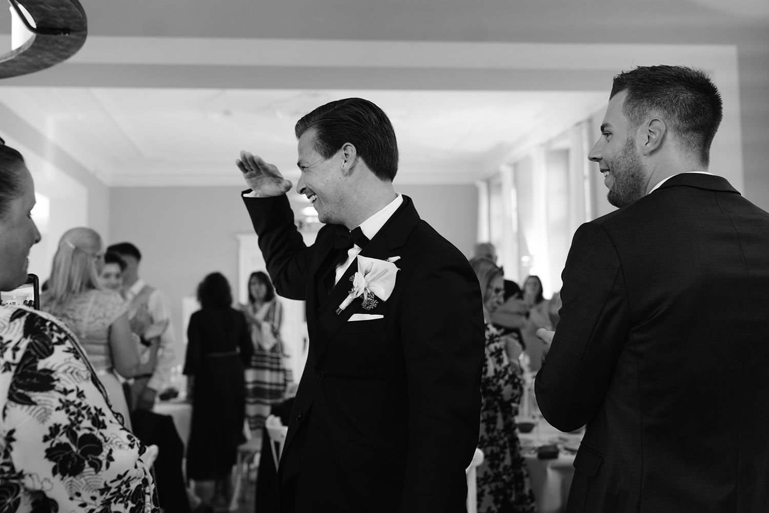 Wedding guests in formal attire showing emotional reactions during a ceremony.