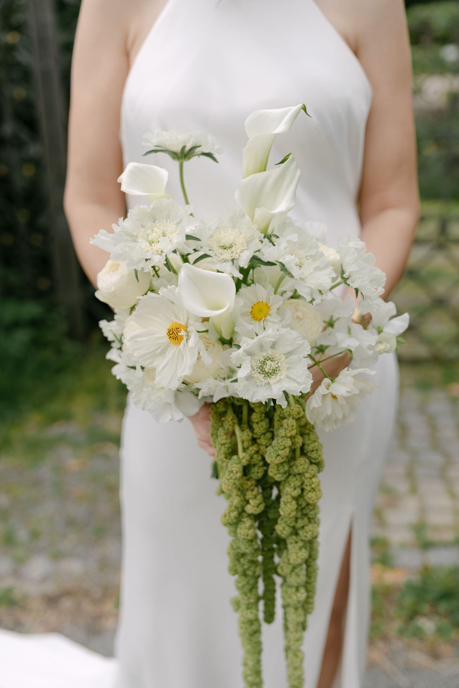 Elegant white bridal bouquet with daisies and cascading green amaranthus.