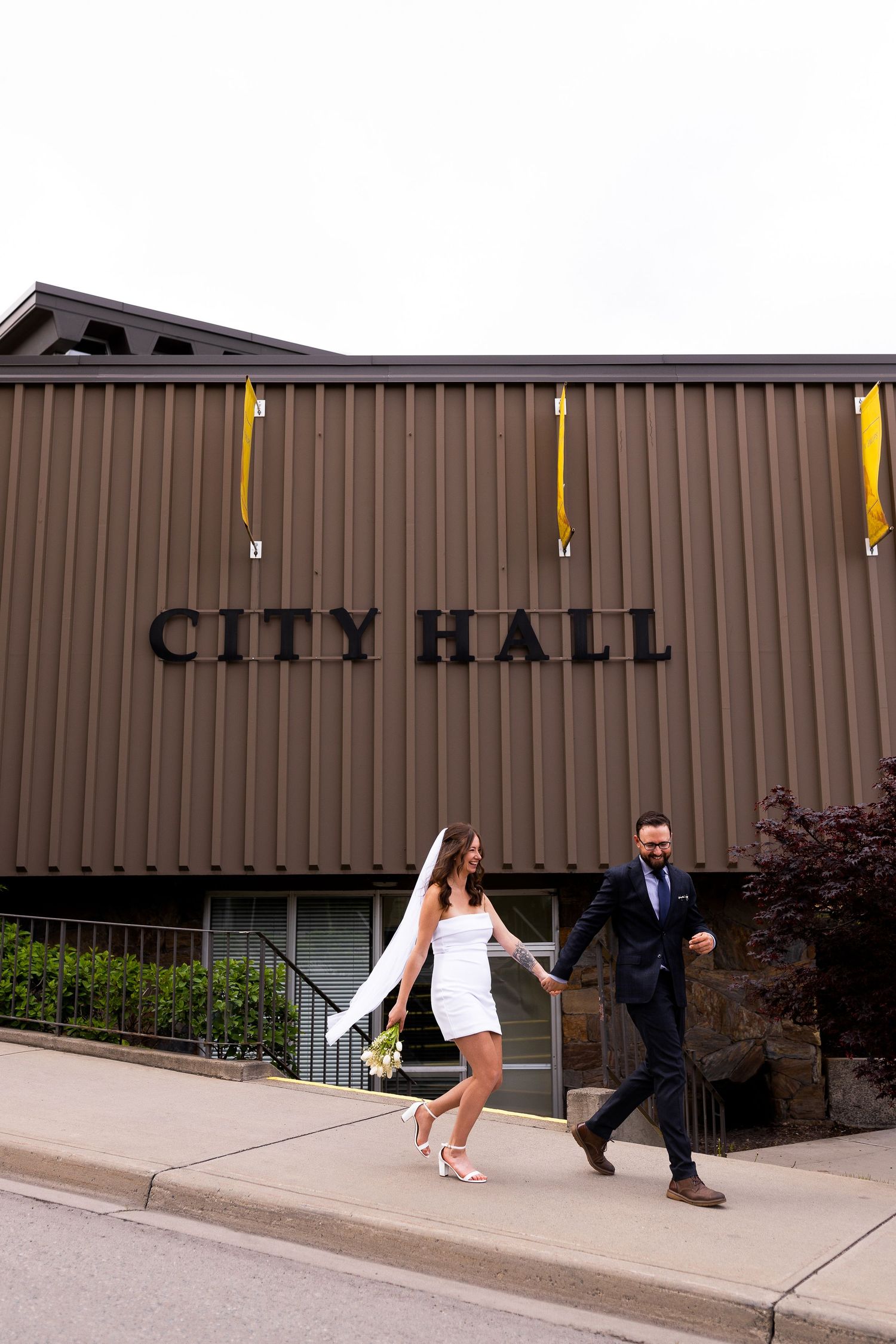 Elopement photo taken downtown Kamloops BC with City Hall in the background.