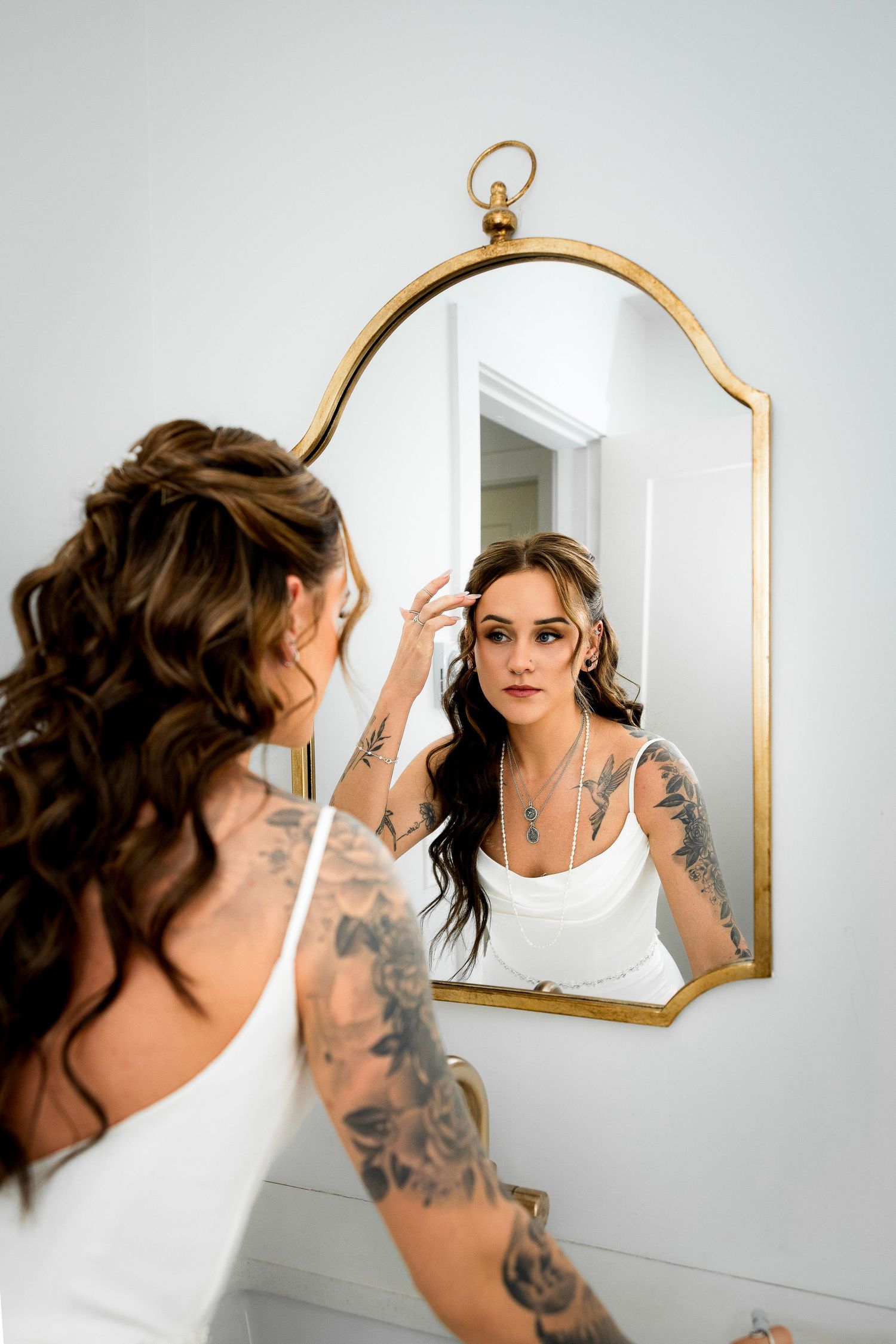Bridal portrait of bride in the mirror during her getting ready pictures on wedding day.