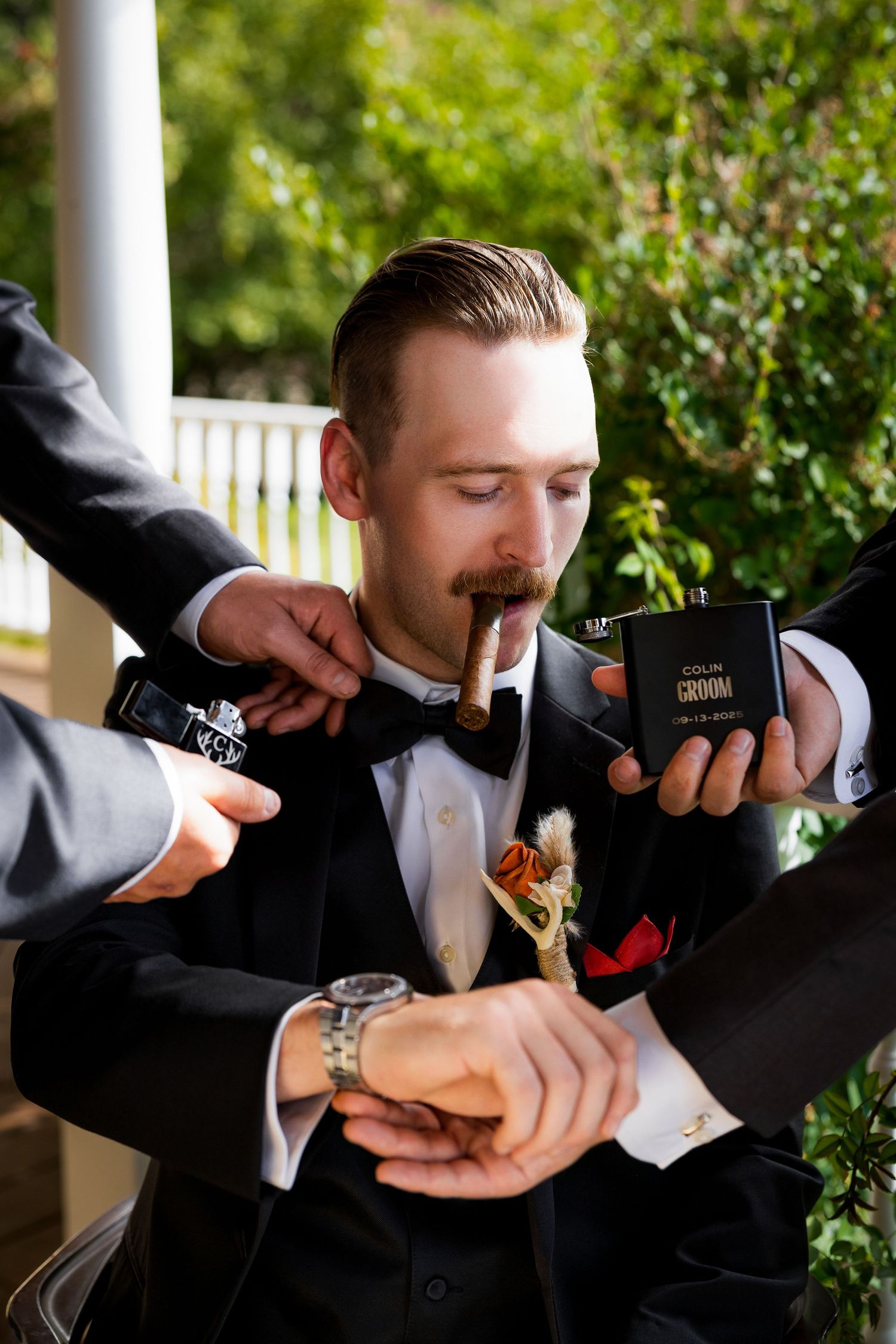 Luxury wedding photo of groom showcasing details like cufflinks, bow tie, and cigar, capturing stylish and elegant wedding photography.