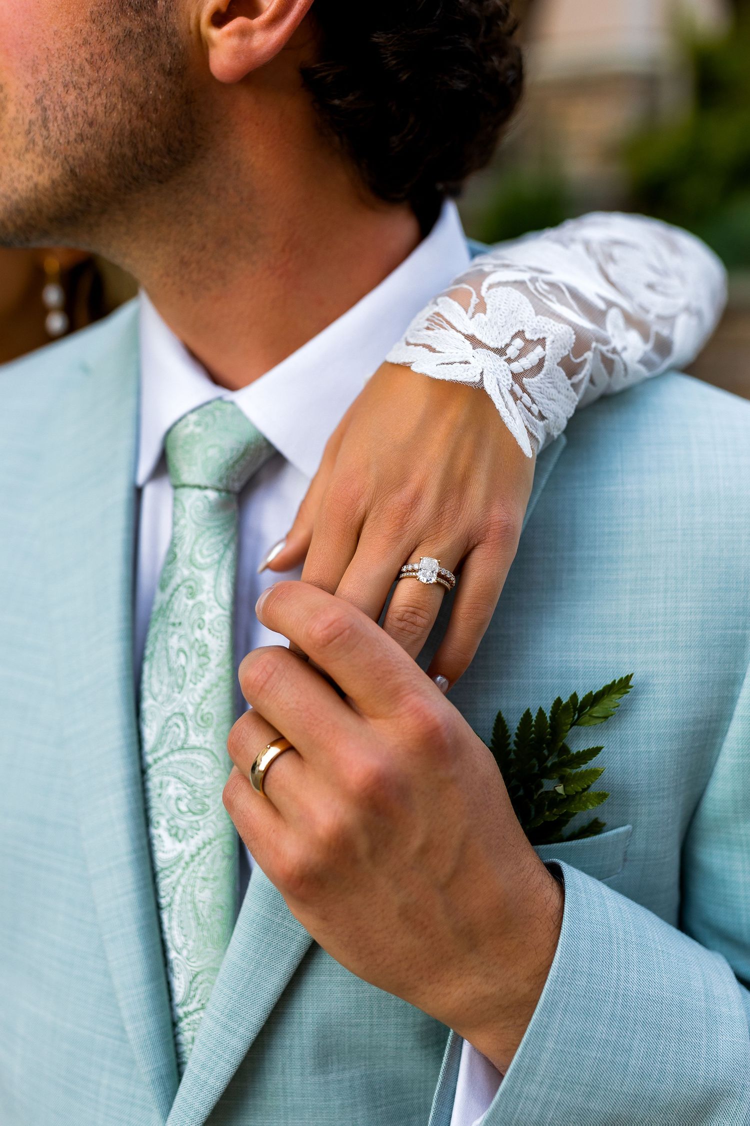 Detail photo of groom’s suit and wedding rings at Sun Peaks Village, capturing stylish and elegant destination wedding photography.