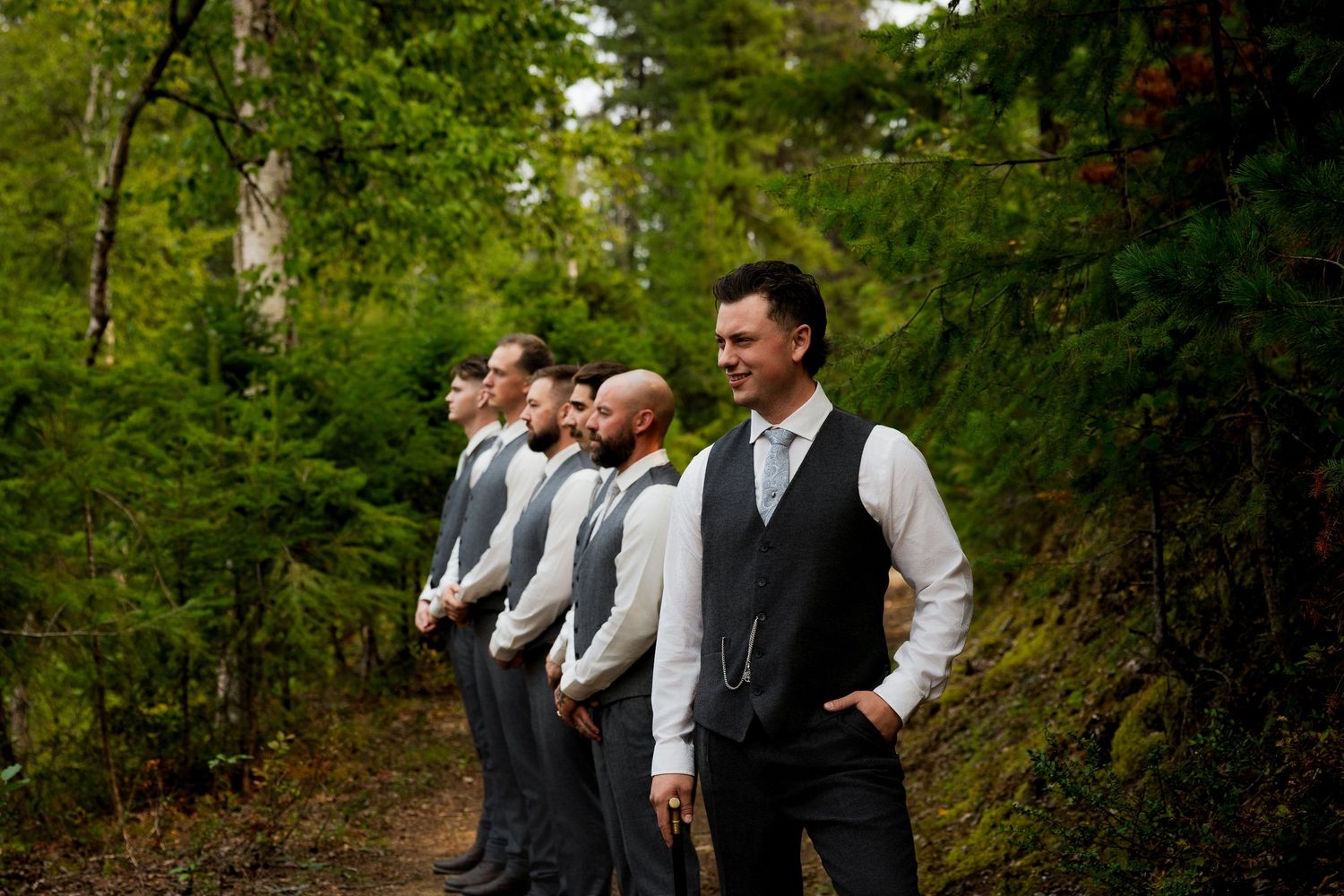 Groom and groomsmen portraits pose for their wedding party photos by a professional wedding photographer.