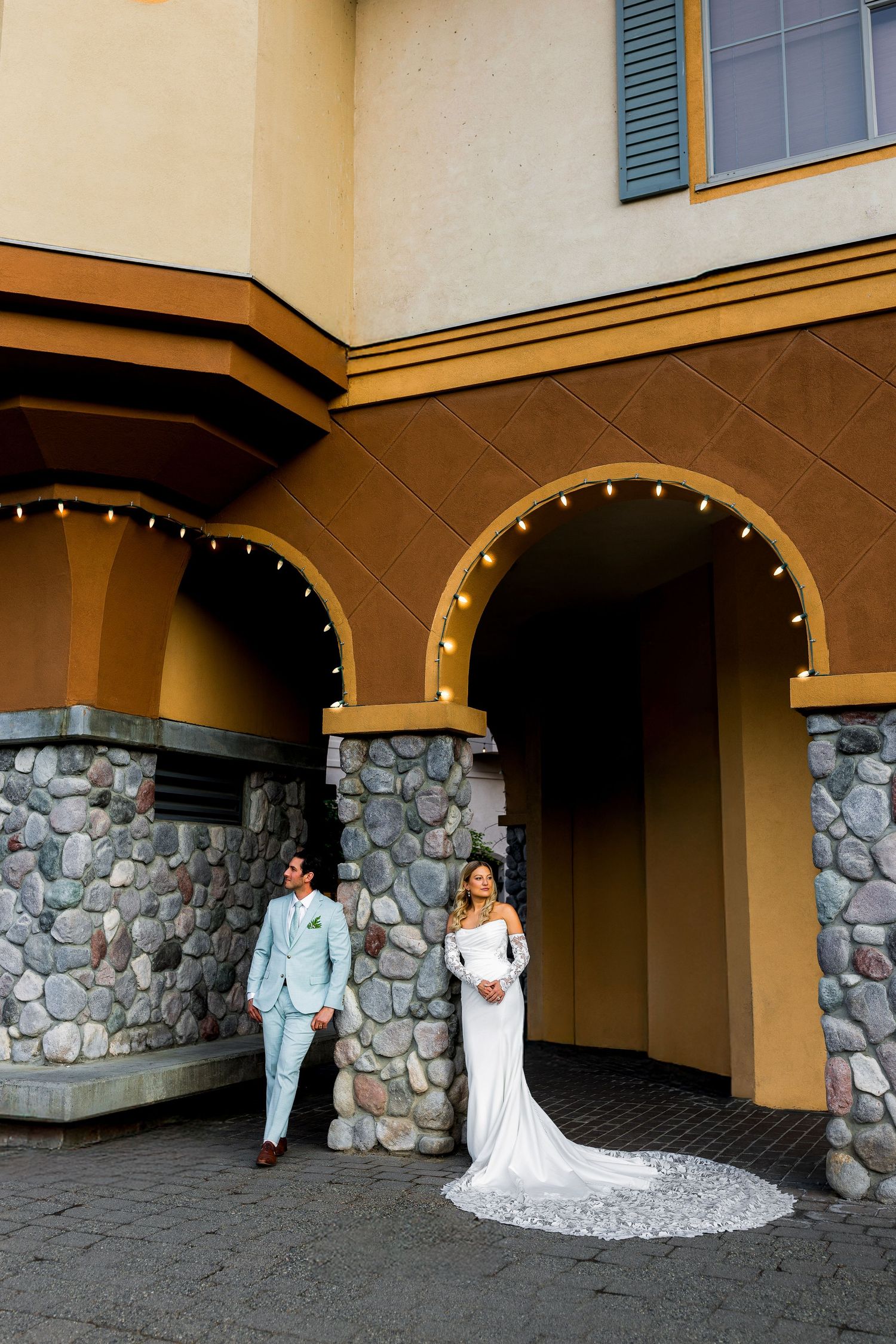 Luxe wedding photo of bride and groom in Sun Peaks Resort village, capturing romantic, stylish, and vibrant destination wedding photography.
