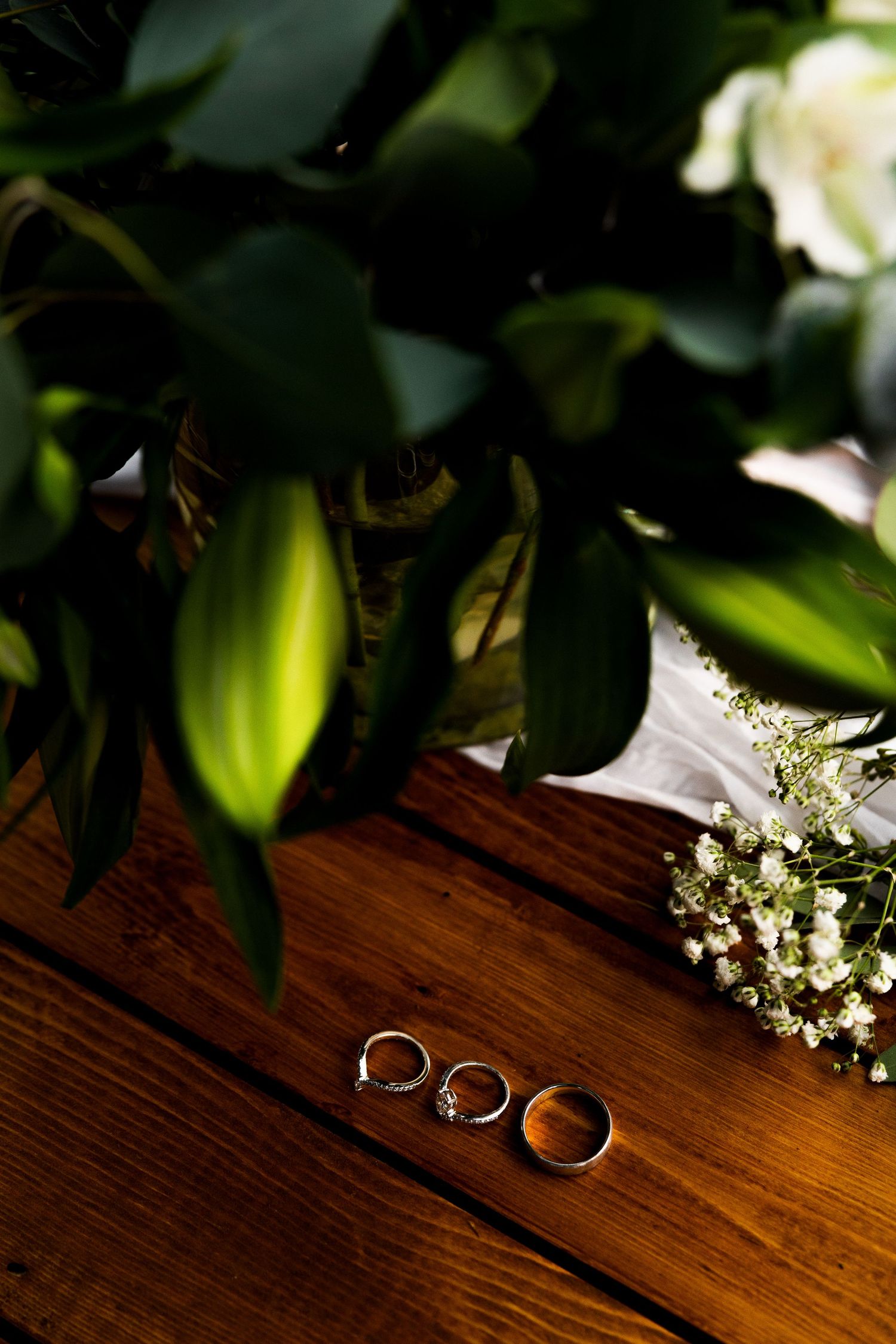 Luxury wedding detail photo of three wedding rings on a table, capturing elegant bridal jewelry and stylish wedding photography.