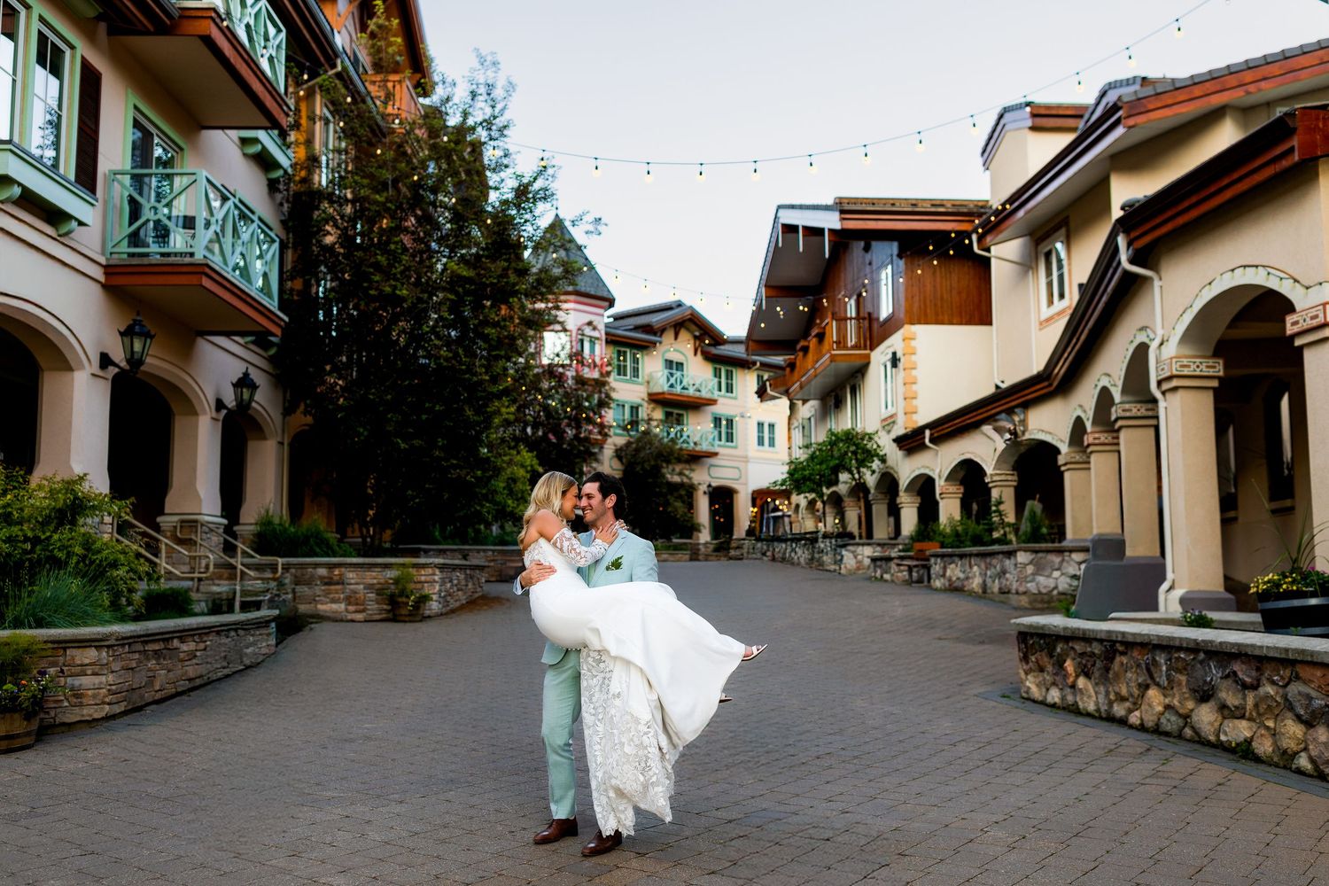 Romantic wedding photo of couple kissing in Sun Peaks after their ceremony, capturing joyful and intimate destination wedding moments.