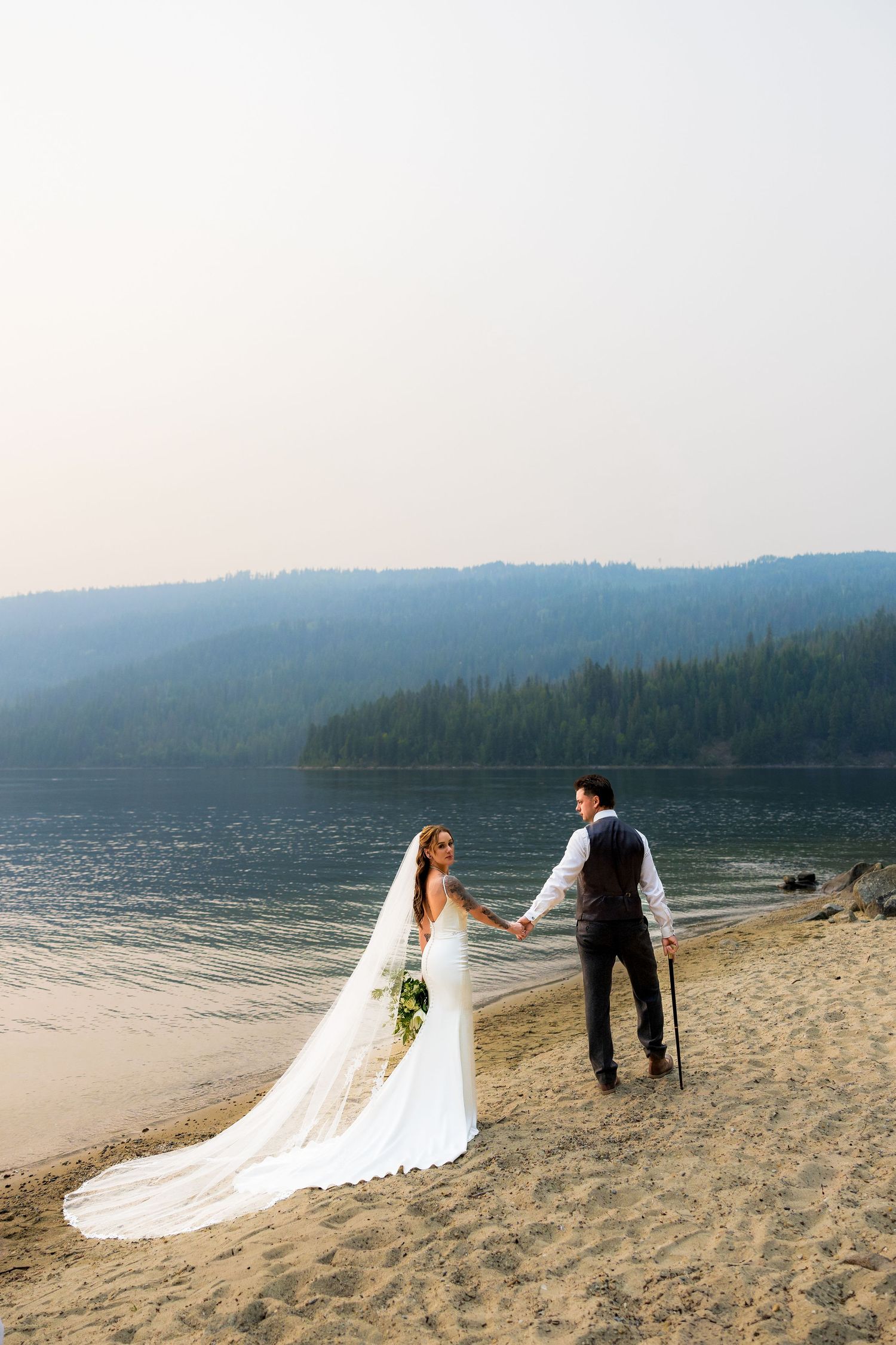 Luxury wedding photo of bride and groom standing on a beach, capturing romantic, intimate, and stylish destination wedding photography.