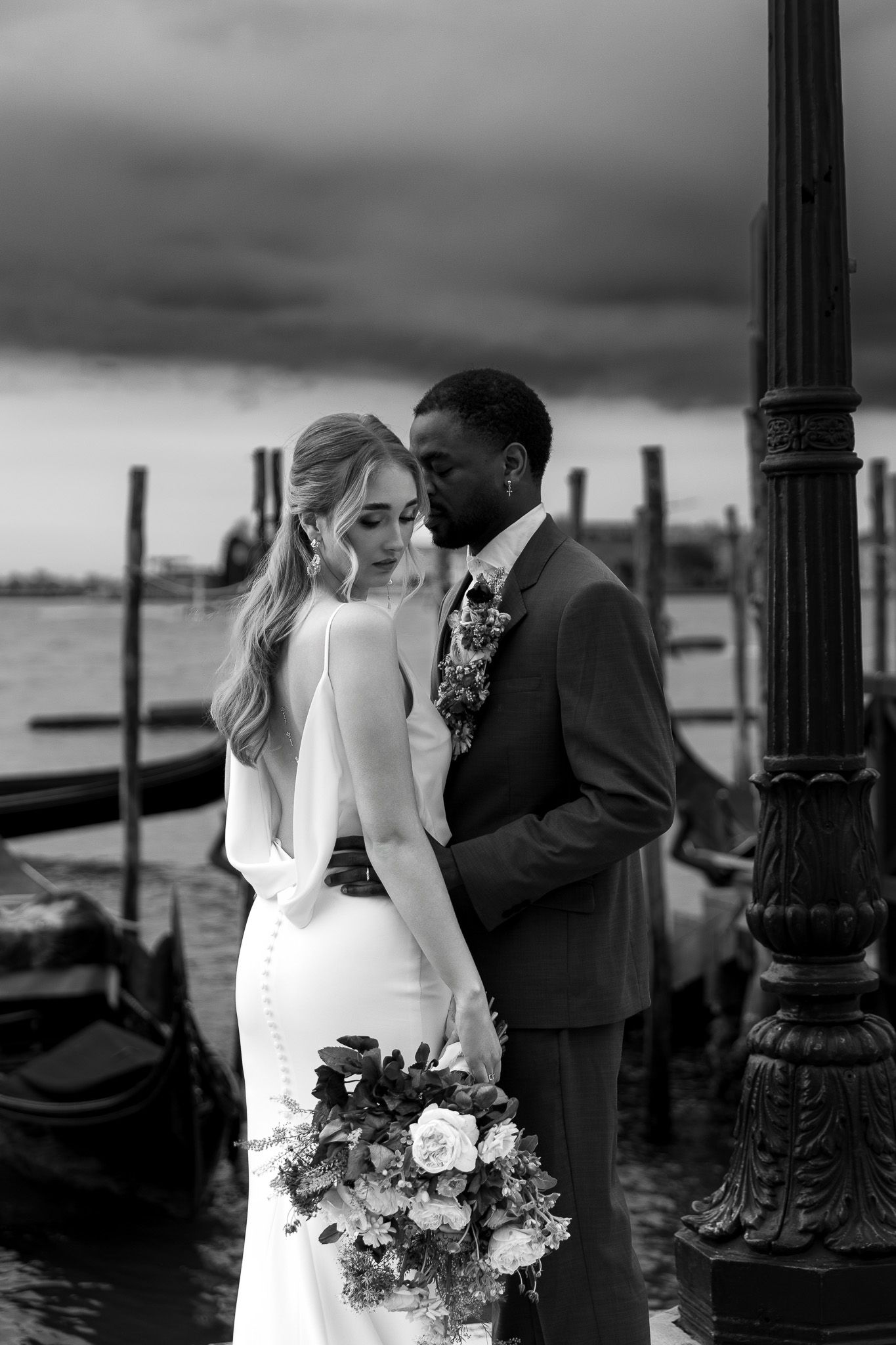 Luxury wedding photo of couple standing outside San Marco Piazza in Venice, capturing romantic and stylish destination wedding photography.